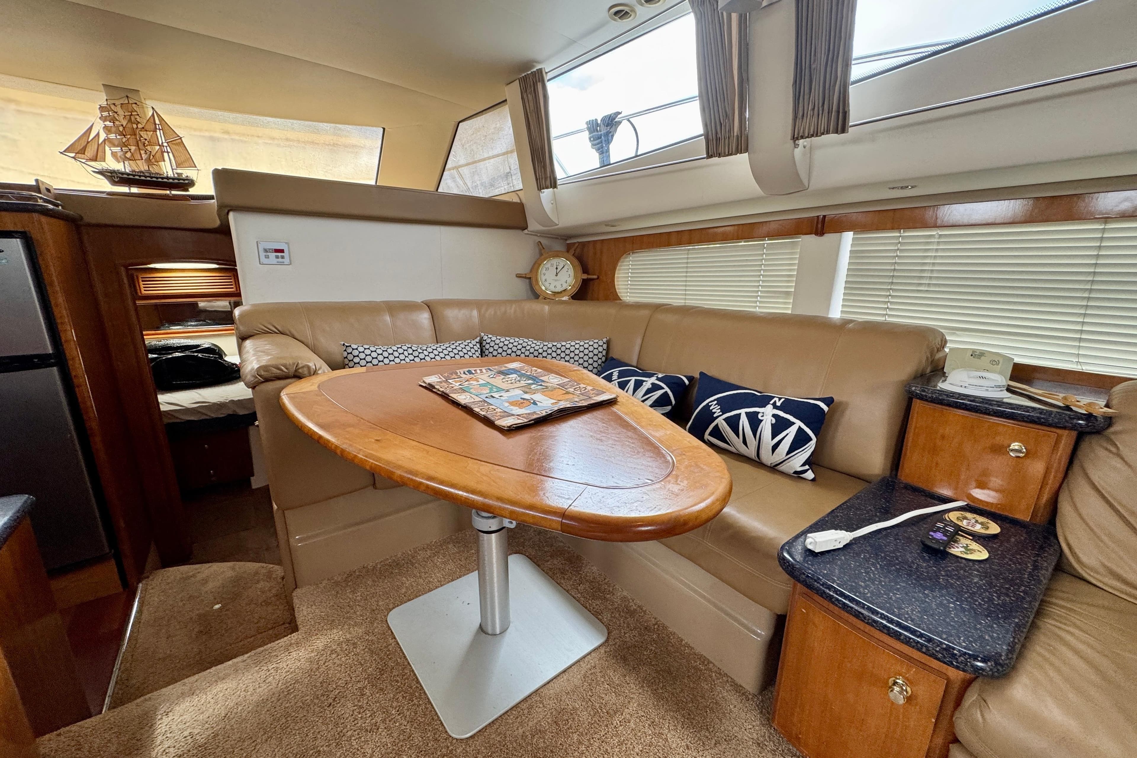 Interior of 2002 Carver 466 Motor Yacht with elegant seating and wooden table.