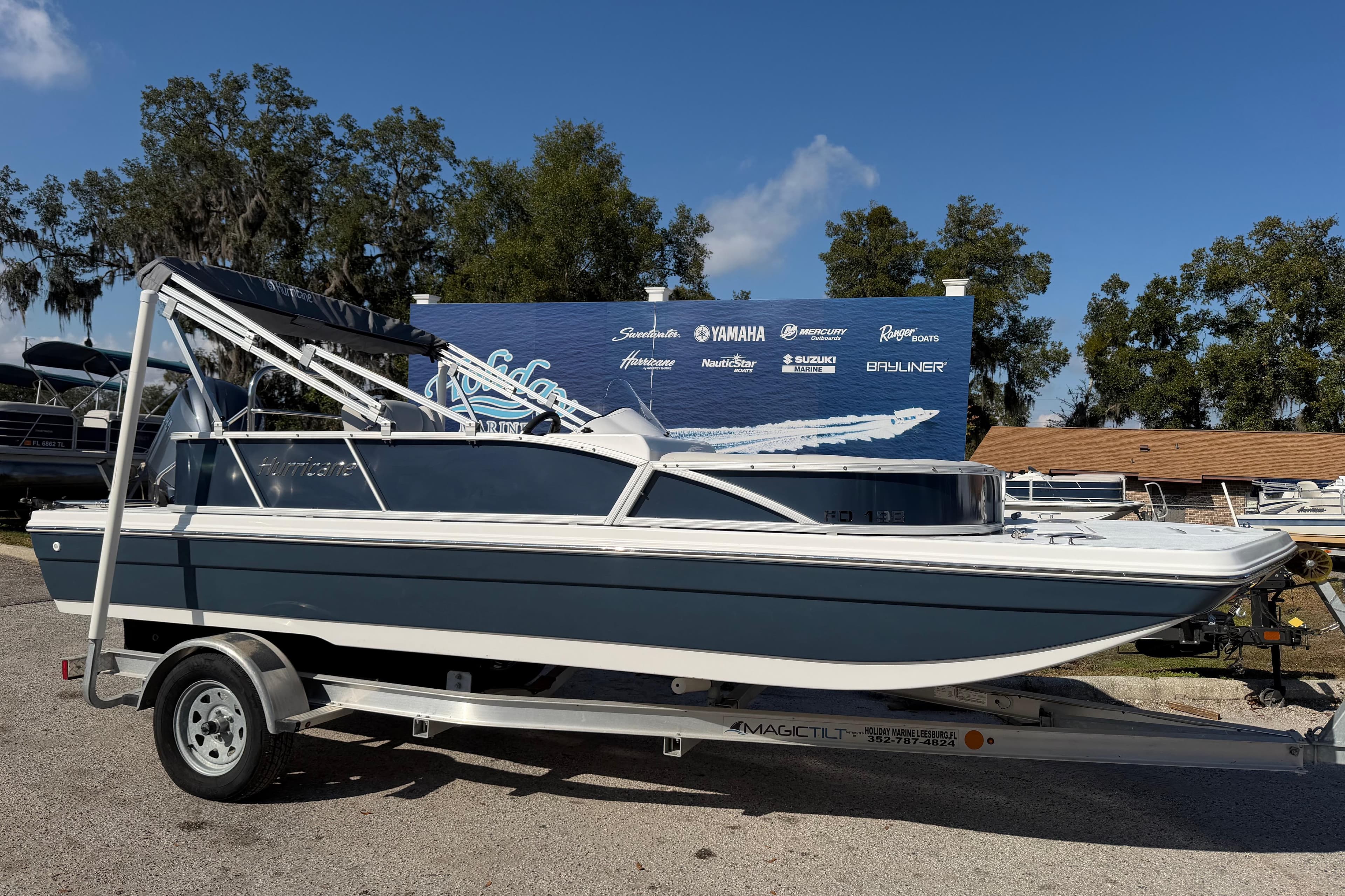 2026 Hurricane FunDeck 198 RE OB boat on trailer, outdoor display setting.