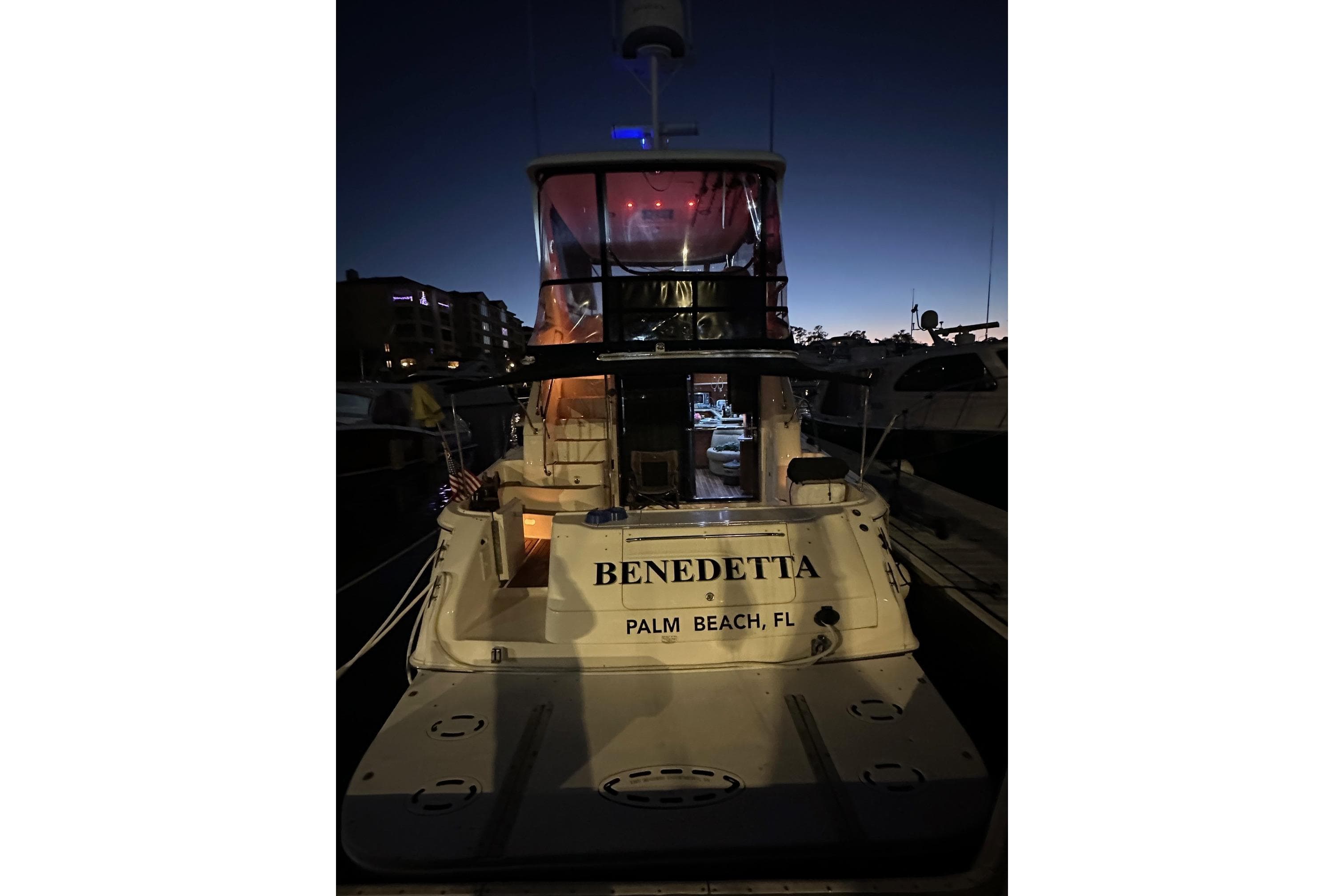 1998 Sea Ray 480 Sedan Bridge yacht docked at night in Palm Beach, FL.