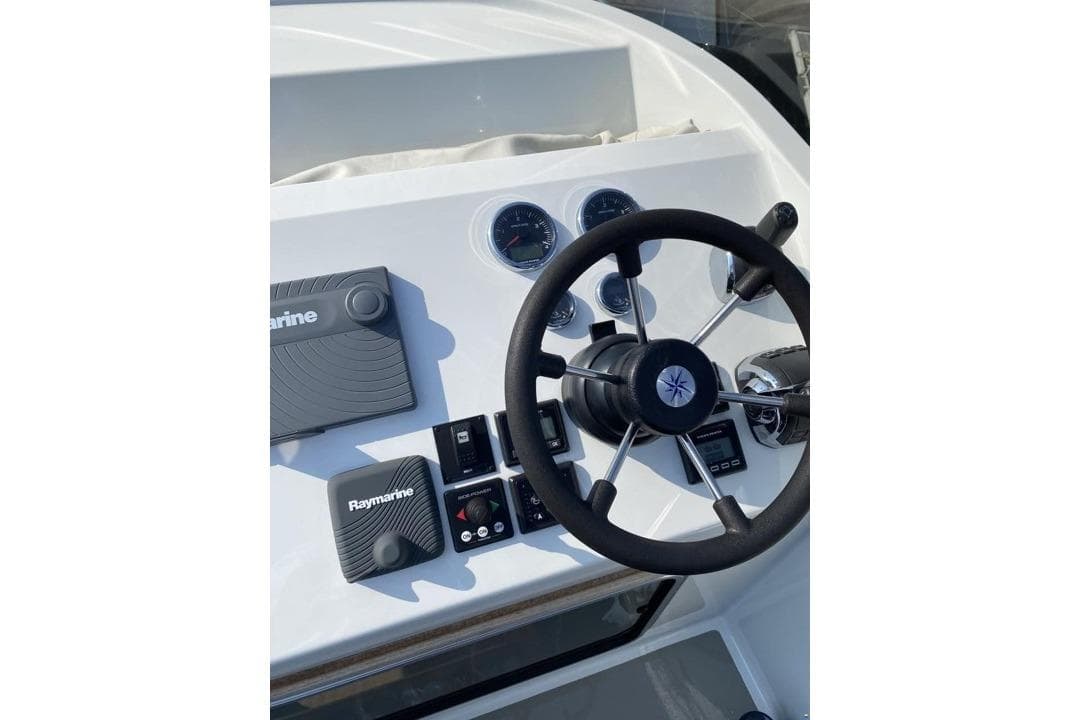 Steering console of 2016 Targa 32 boat with Raymarine controls and gauges.