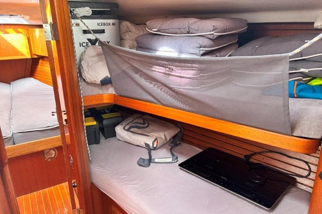 Cozy cabin interior of 1994 X-Yachts X-442 with storage and bedding.