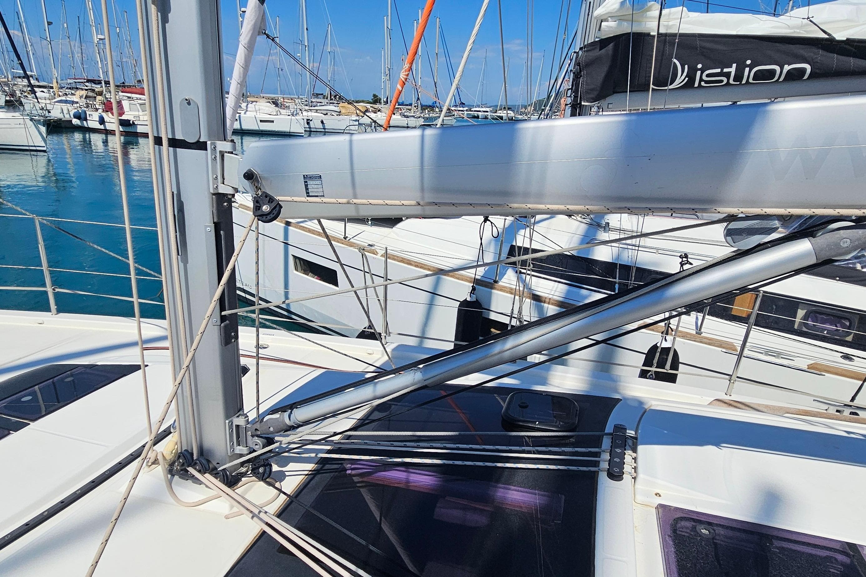 Dufour 390 sailboat deck with rigging, docked in a marina, 2020 model.