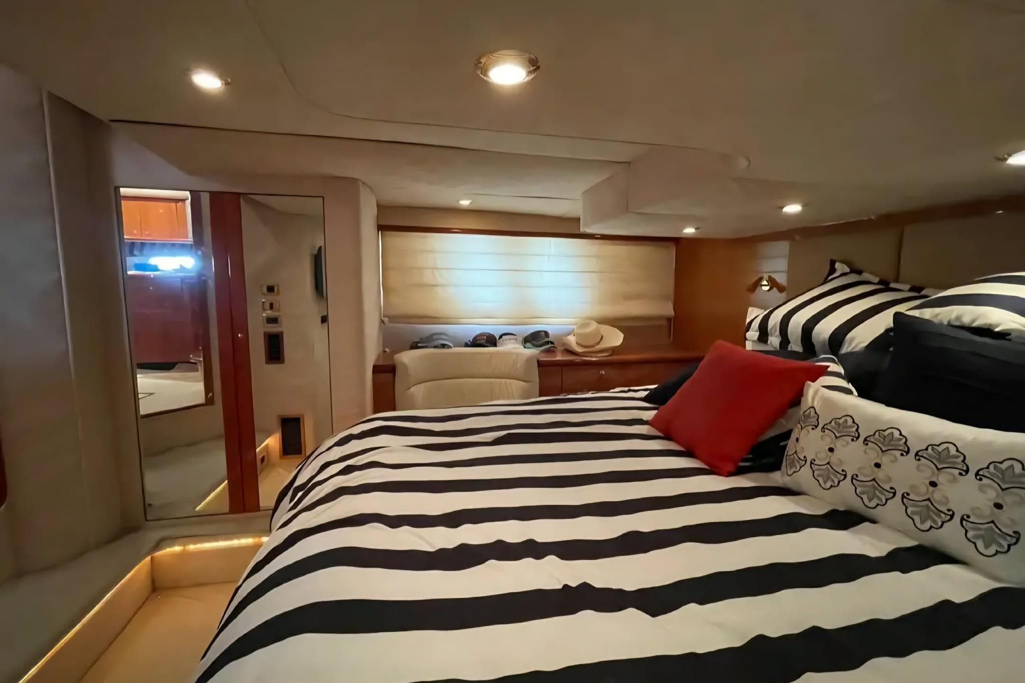 Luxurious cabin interior of 2004 Sunseeker Predator 56 yacht with striped bedding.