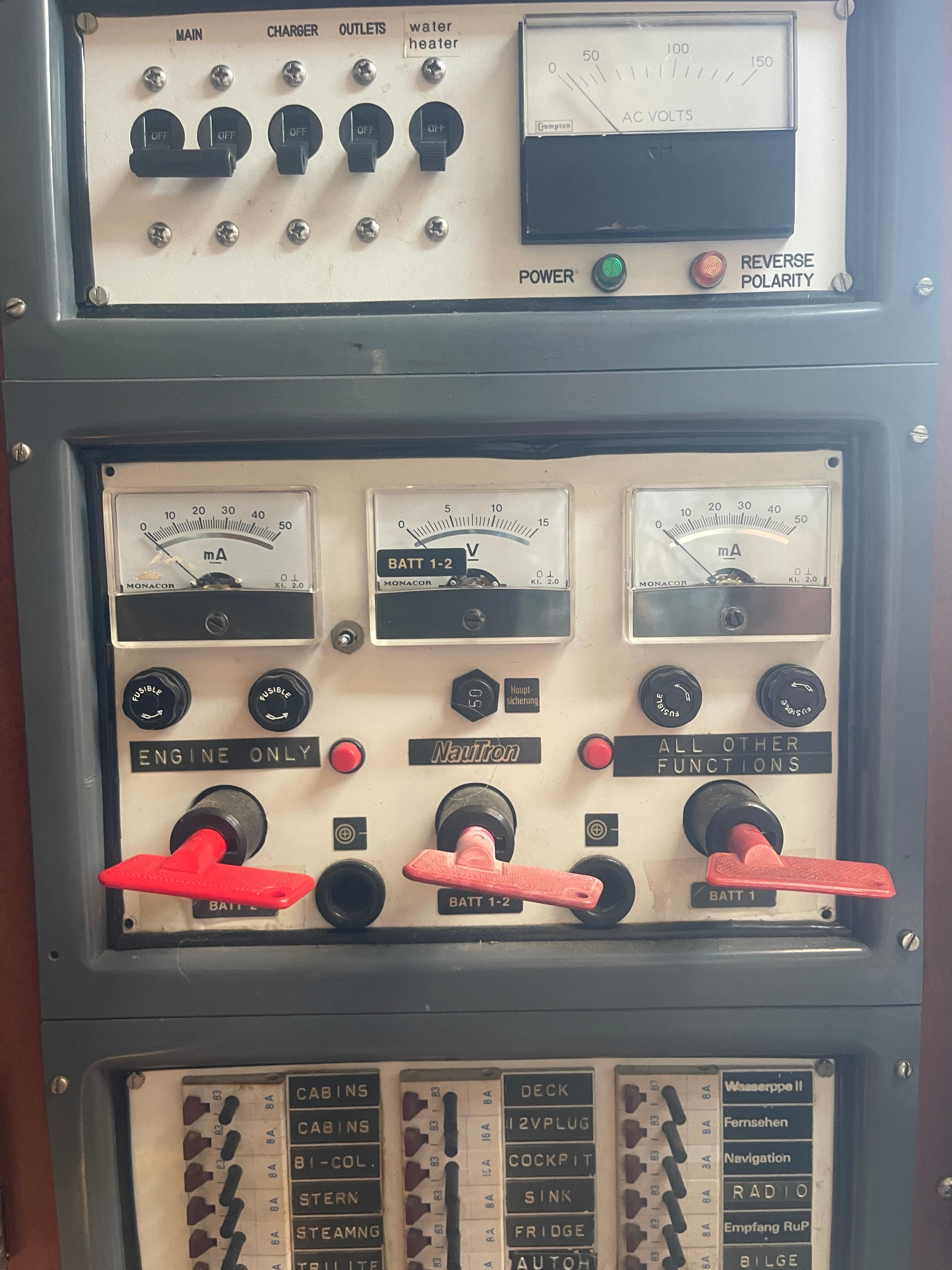 Control panel of a 1984 Hanseat 37 boat with gauges and switches.