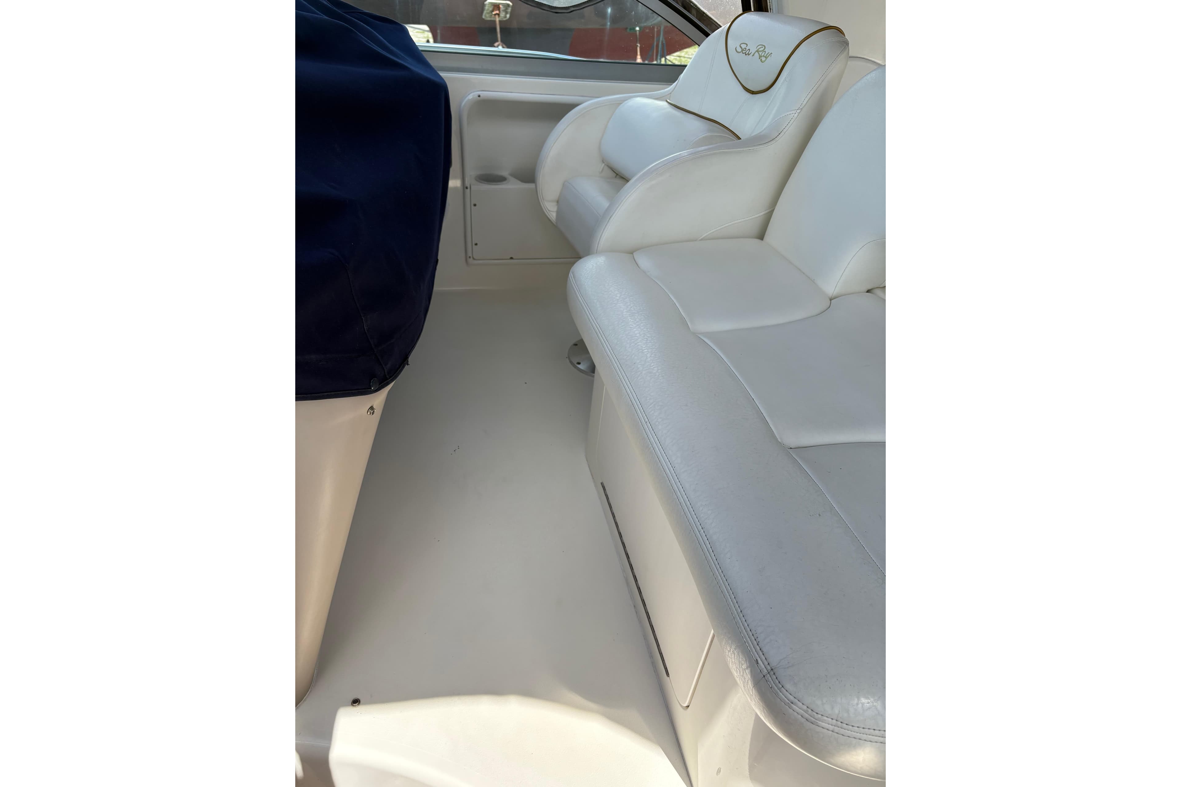 Interior seating of 2000 Sea Ray 340 Sundancer boat, featuring white leather upholstery.