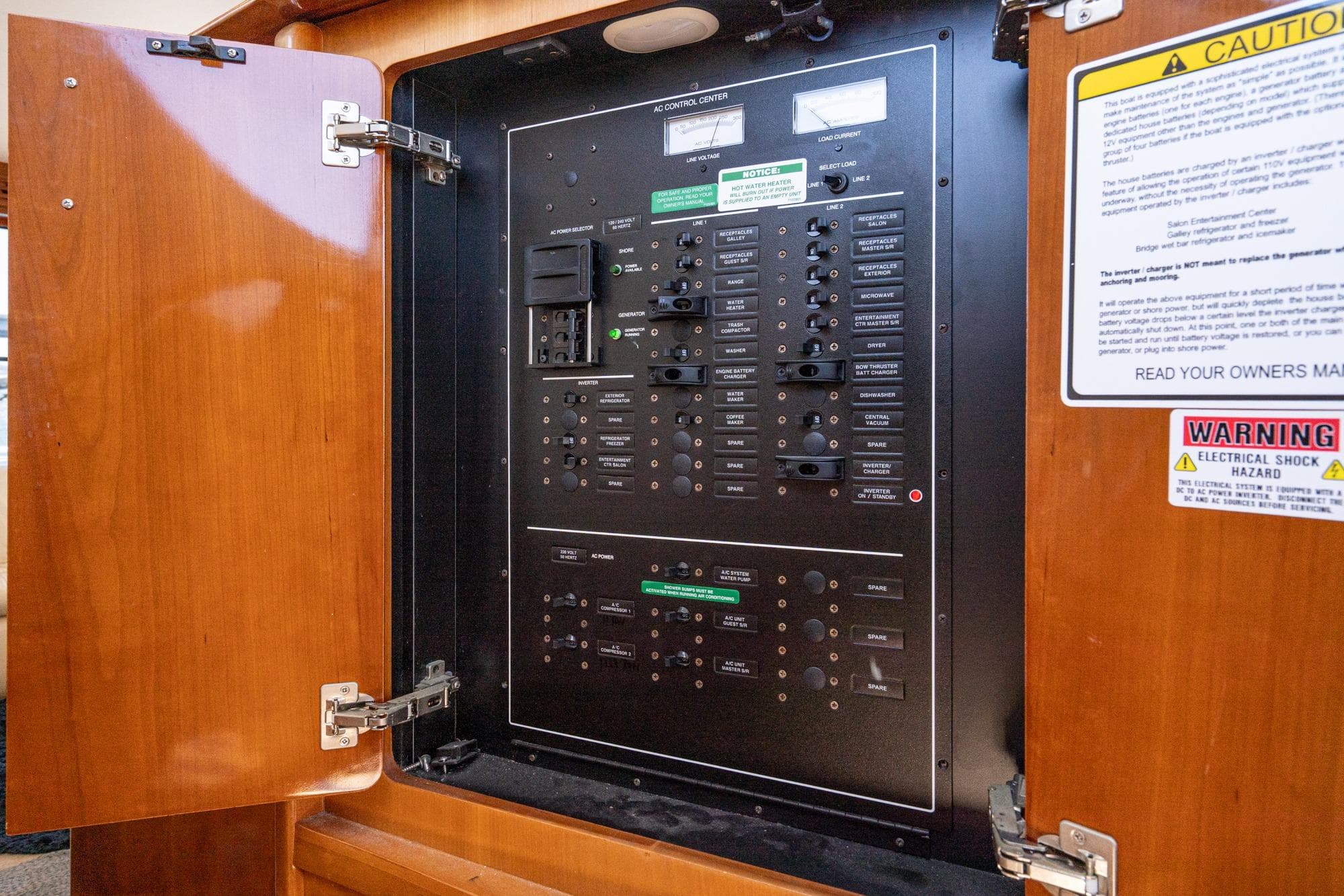 Electrical control panel inside 2003 Carver 530 Voyager Pilothouse yacht, featuring safety warnings.