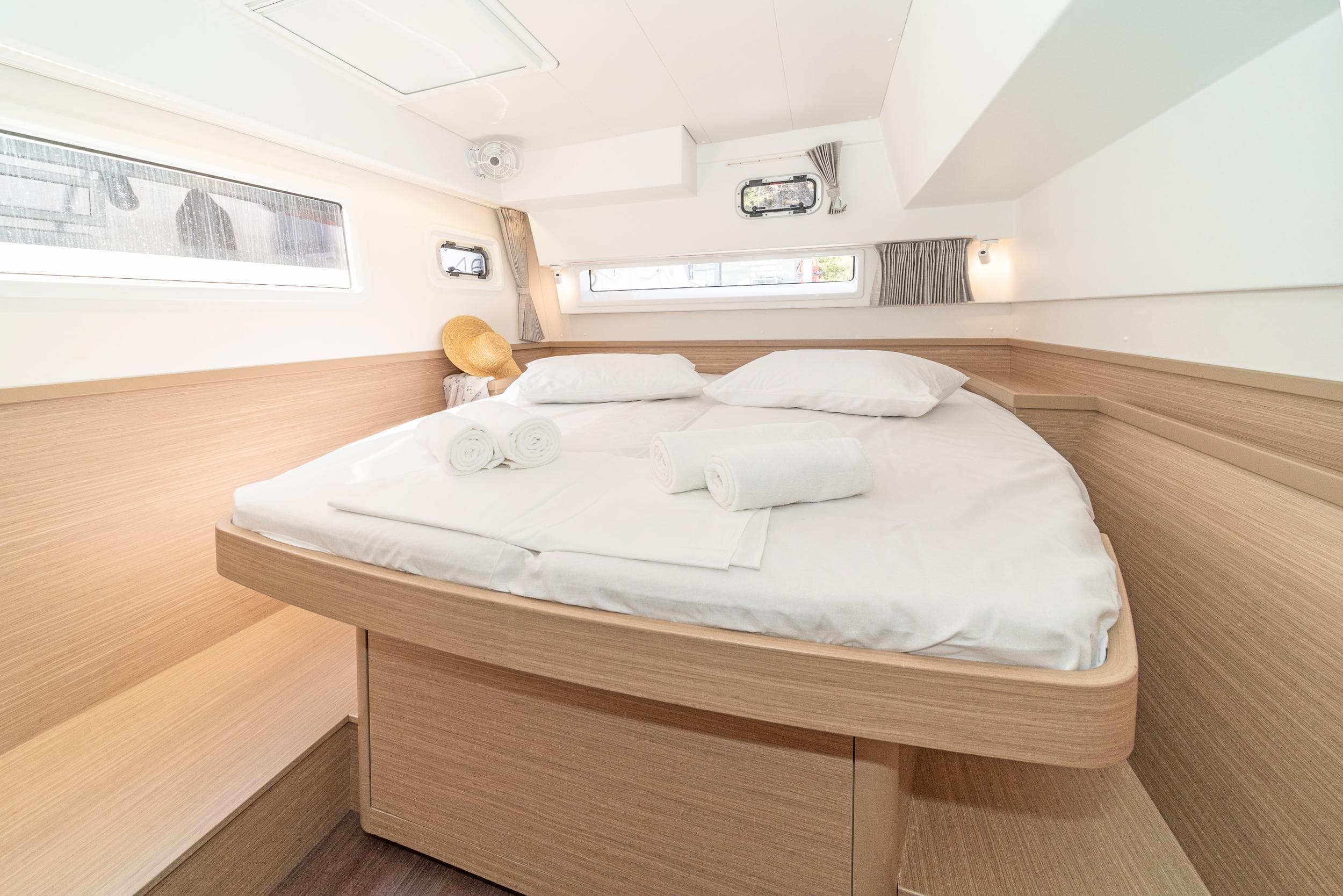 2023 Lagoon 42 yacht cabin with cozy bed and modern design.