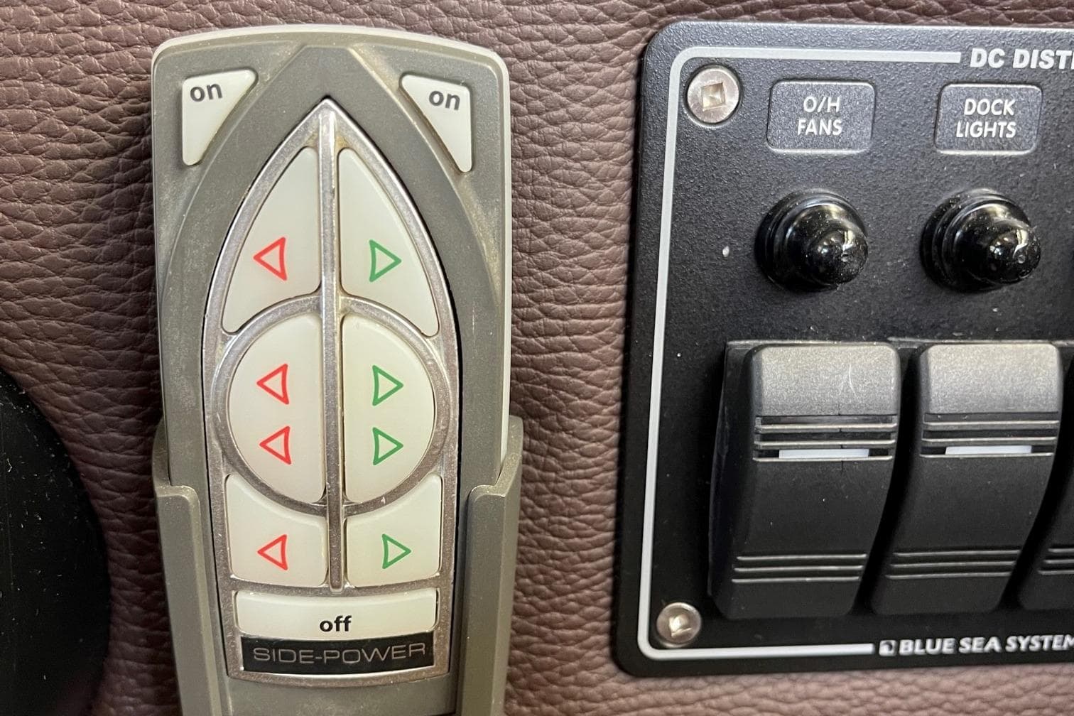 Control panel of a 2015 Cutwater C-28 boat with Side-Power and Blue Sea Systems switches.