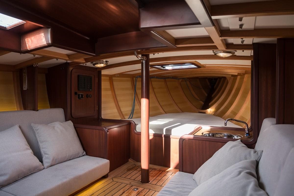 Luxurious interior of 2017 Hoek Classic 33 yacht with elegant wood finish and cozy seating.