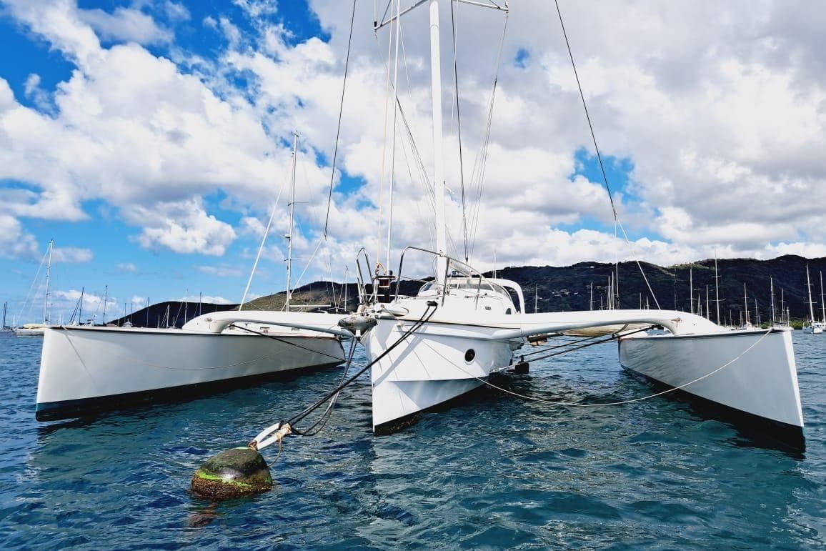 2008 Dragonfly 35 Ultimate trimaran anchored in scenic bay under blue sky.