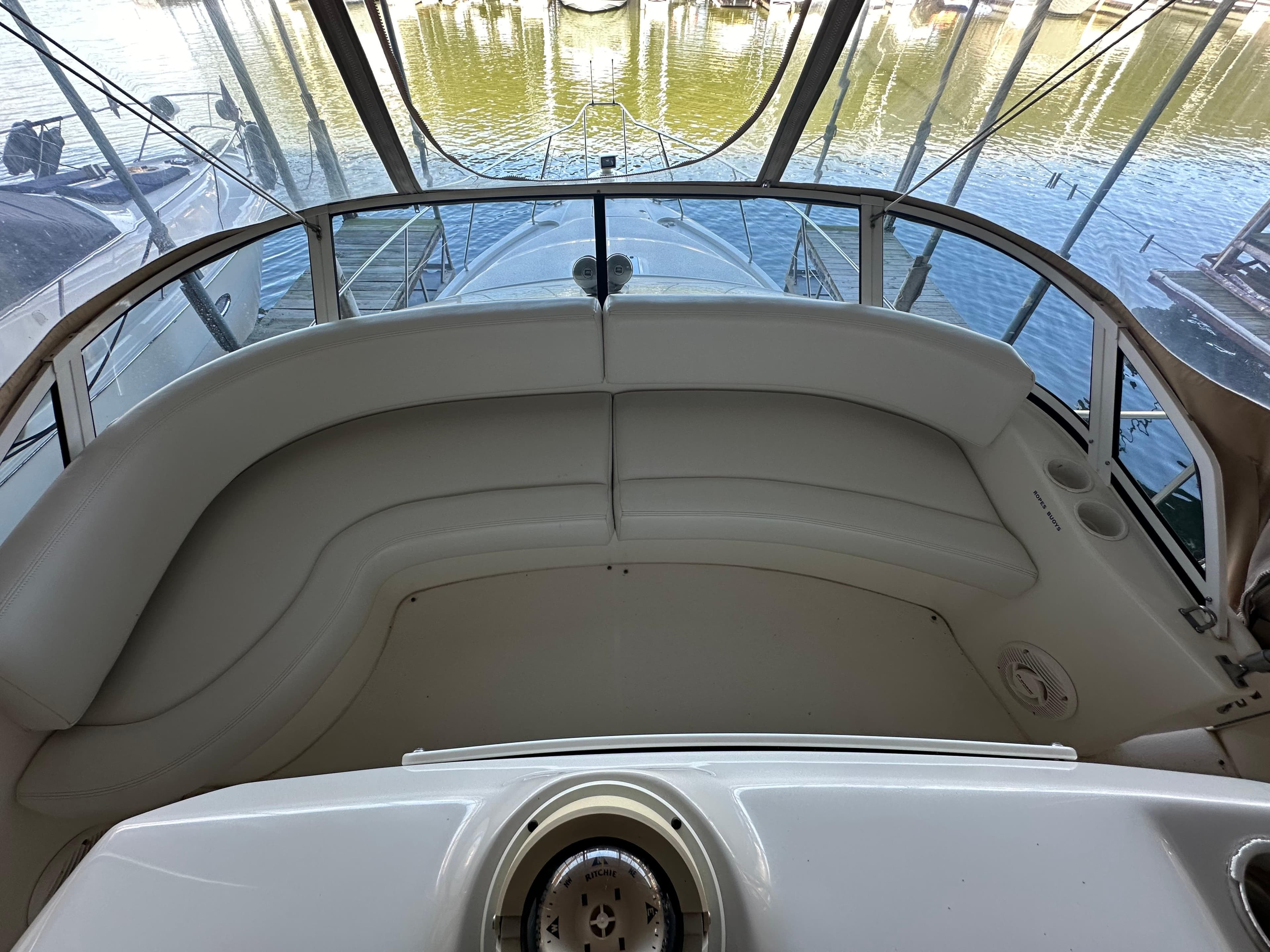 2002 Silverton 35 Convertible boat interior with curved seating and panoramic windows.