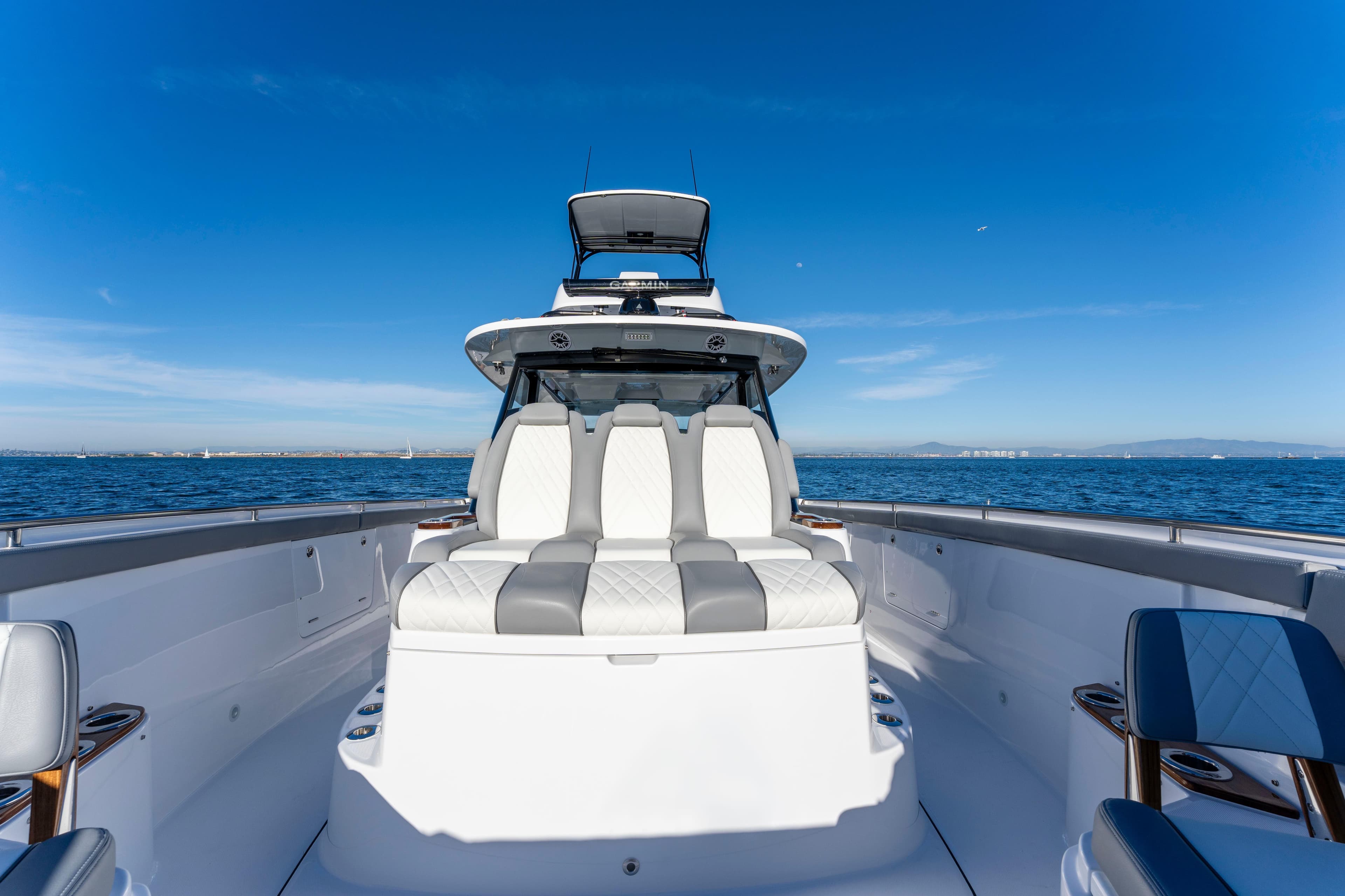 Everglades 455 Center Console 2026 on open sea under clear sky.