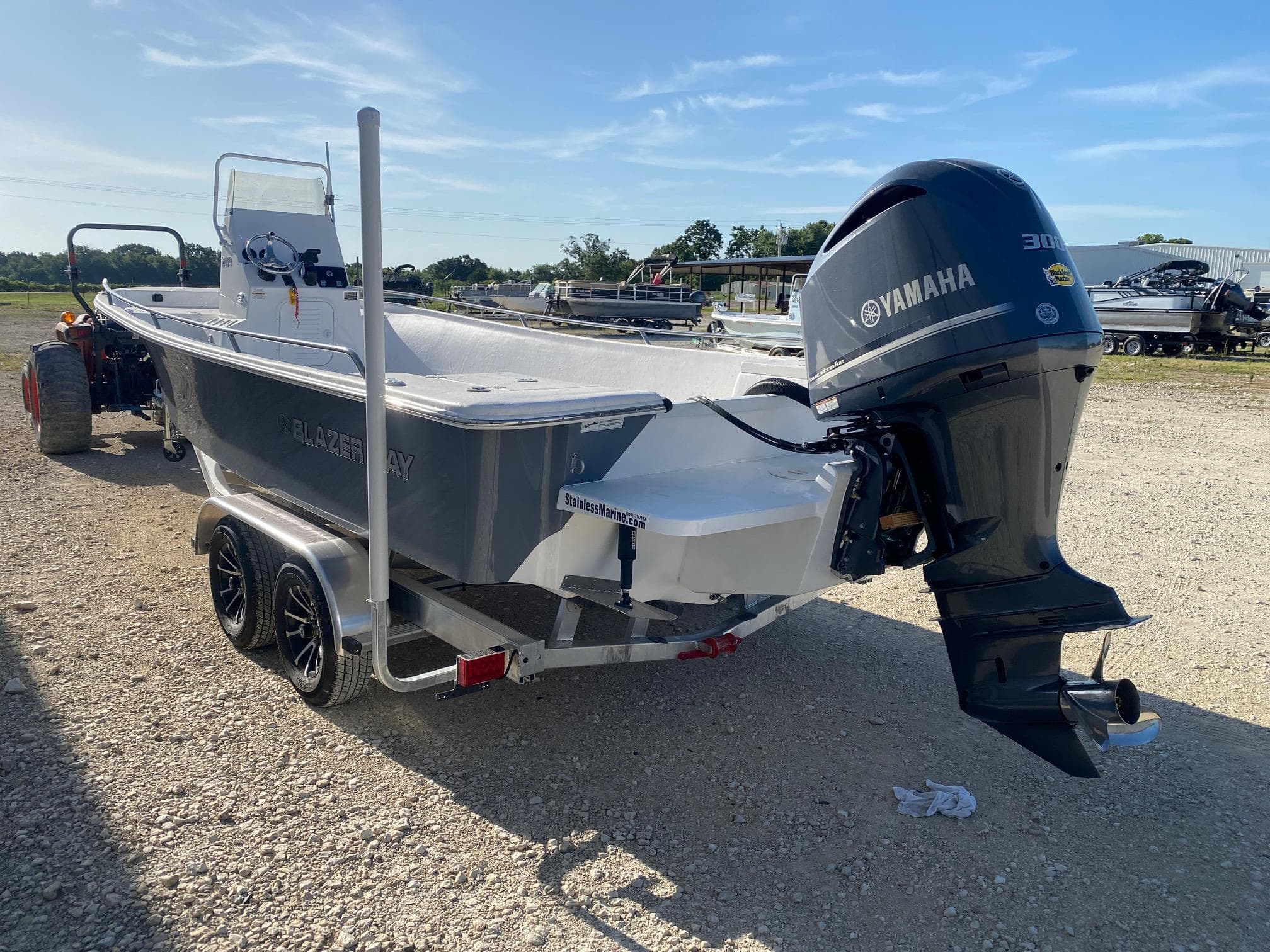 2025 Blazer Bay 2400 Open Bay Striper boat with Yamaha engine on trailer.