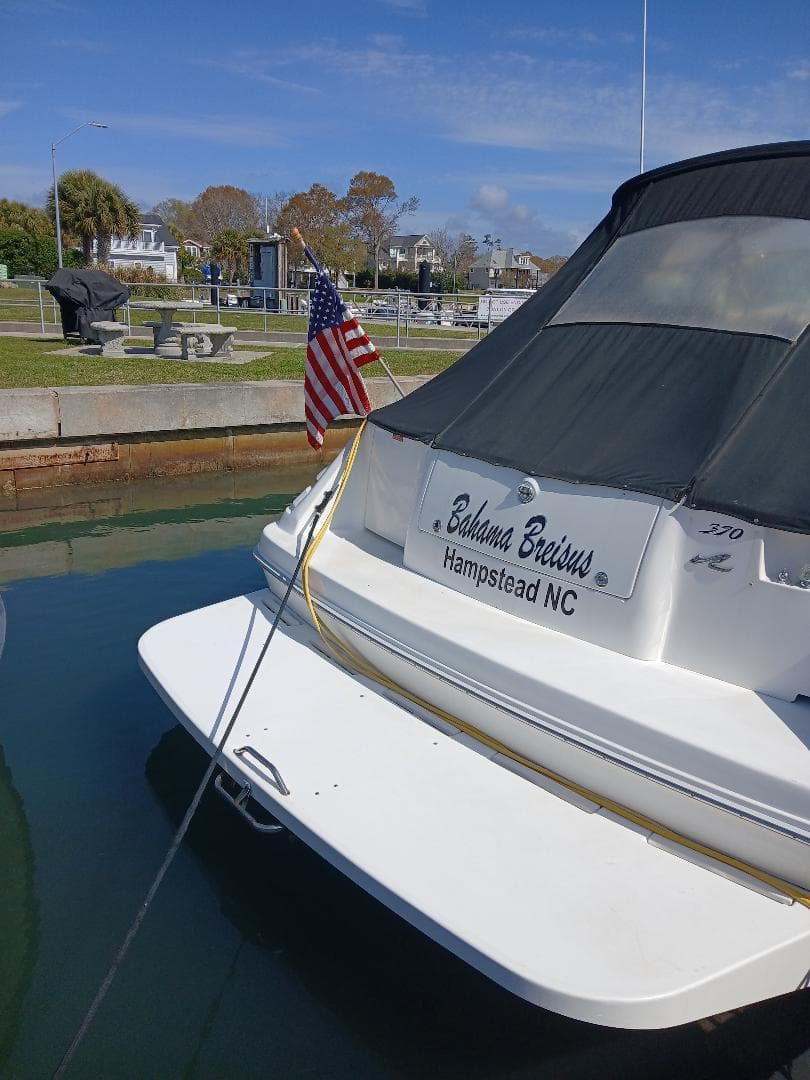 1997 Sea Ray 370 Sundancer docked, displaying American flag, Hampstead NC.