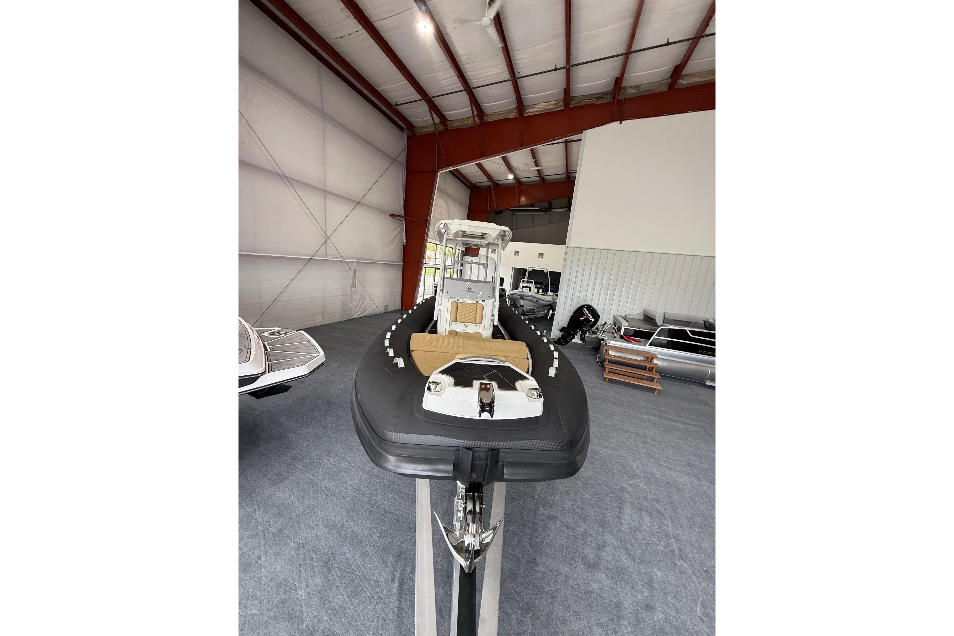 2026 Highfield Sport 800 boat displayed in a spacious indoor showroom.