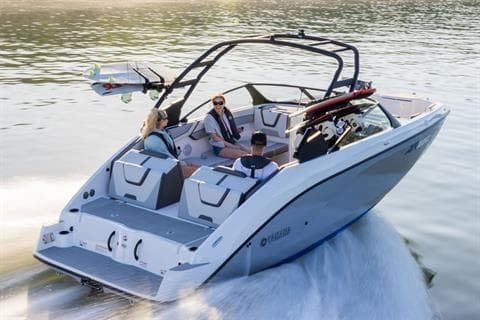 2026 Yamaha Boats AR220 cruising on water with passengers enjoying the ride.