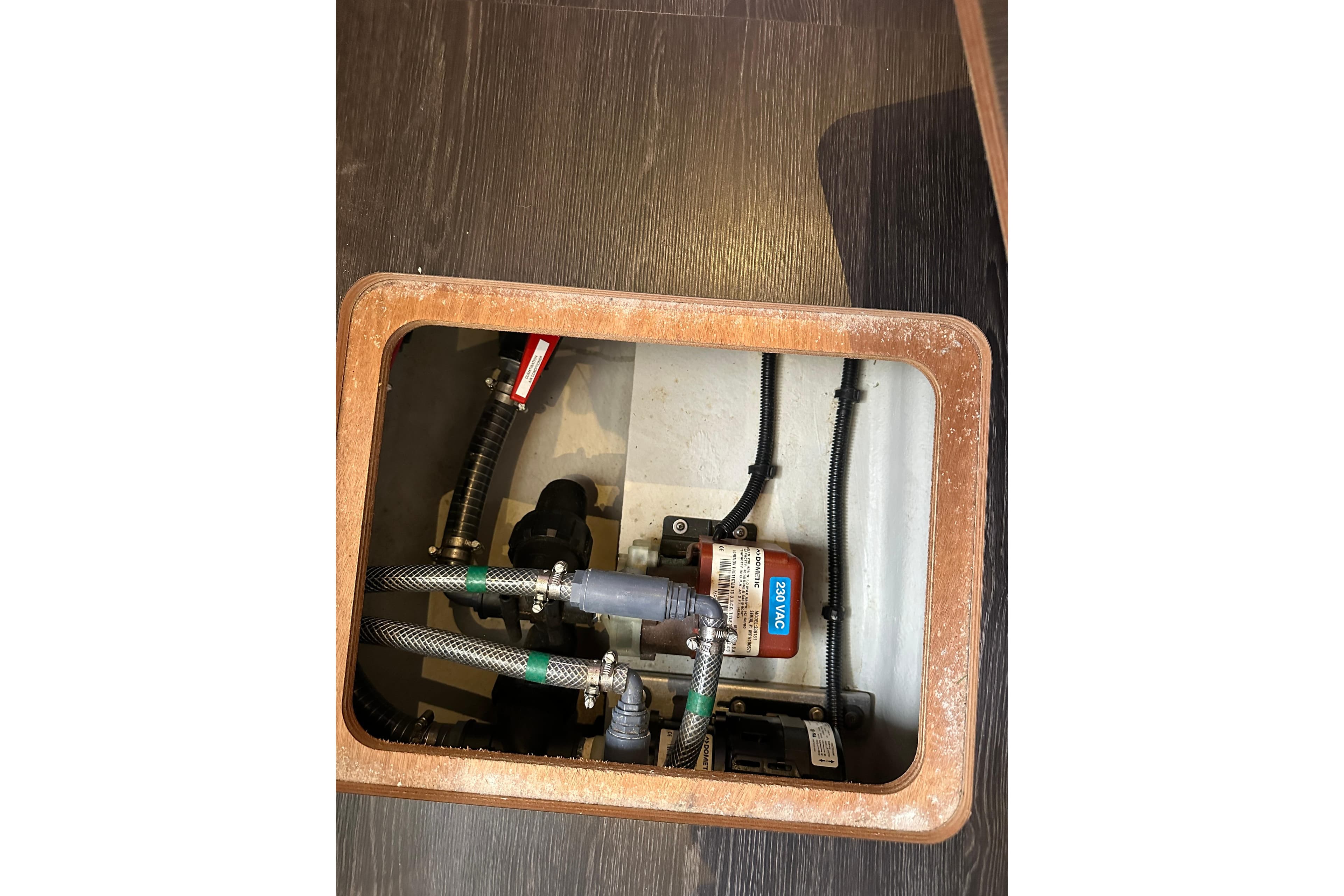 Engine compartment of a 2020 Fountaine Pajot Astrea 42 Catamaran, showing hoses and wiring.