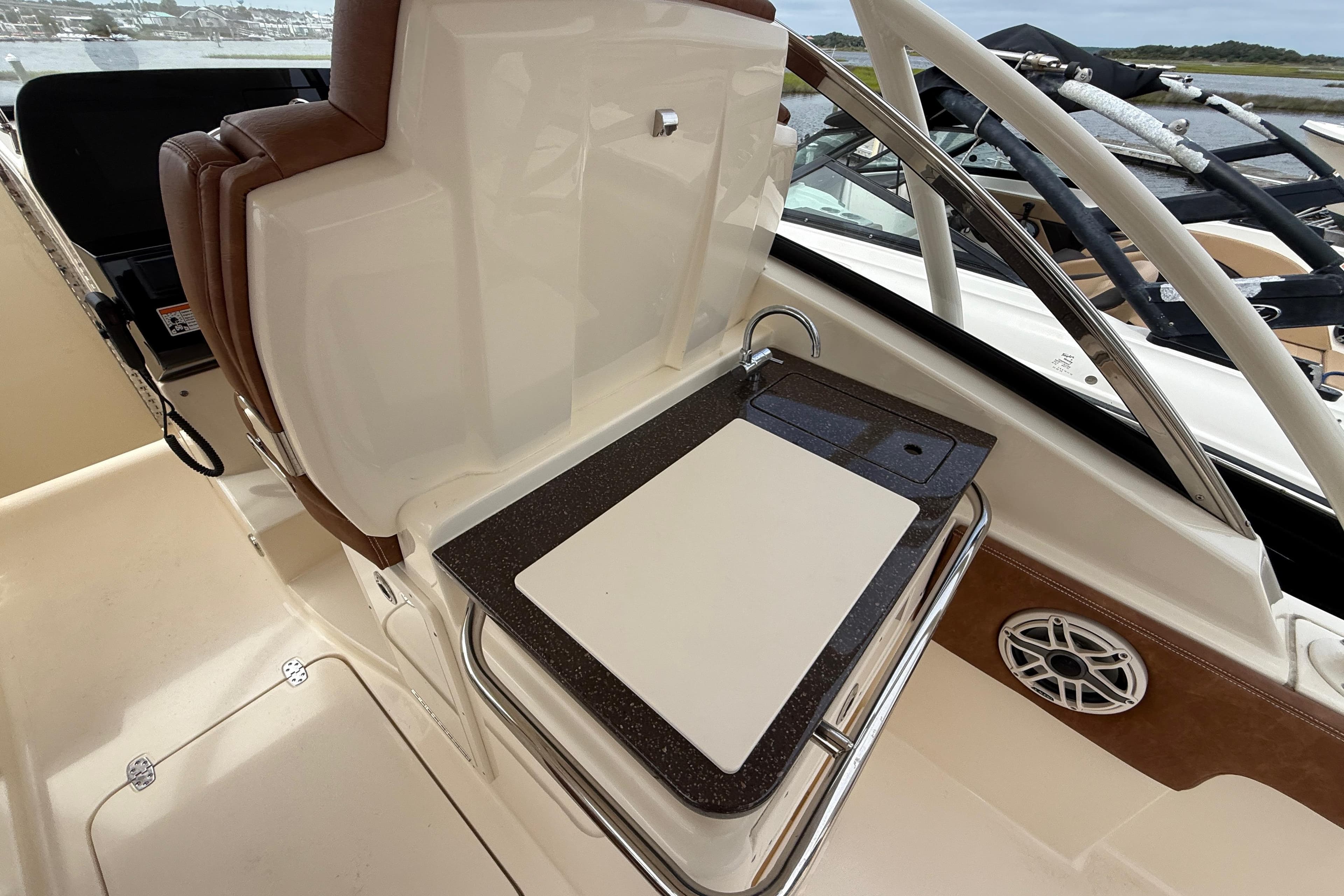 2023 Scout 255 Dorado boat interior with sink and cutting board.
