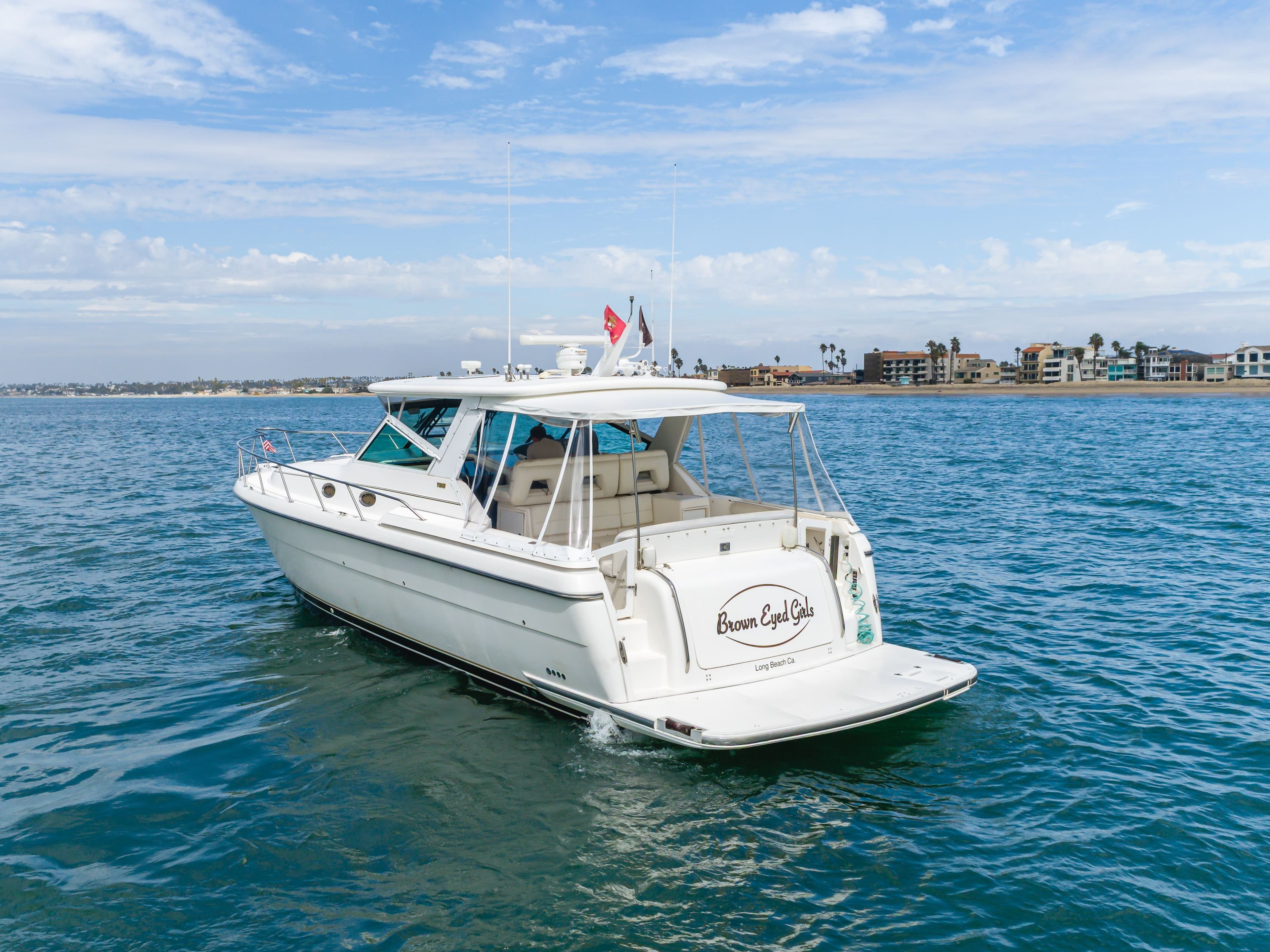 2004 Tiara Yachts 4000 cruising on water near coastline.