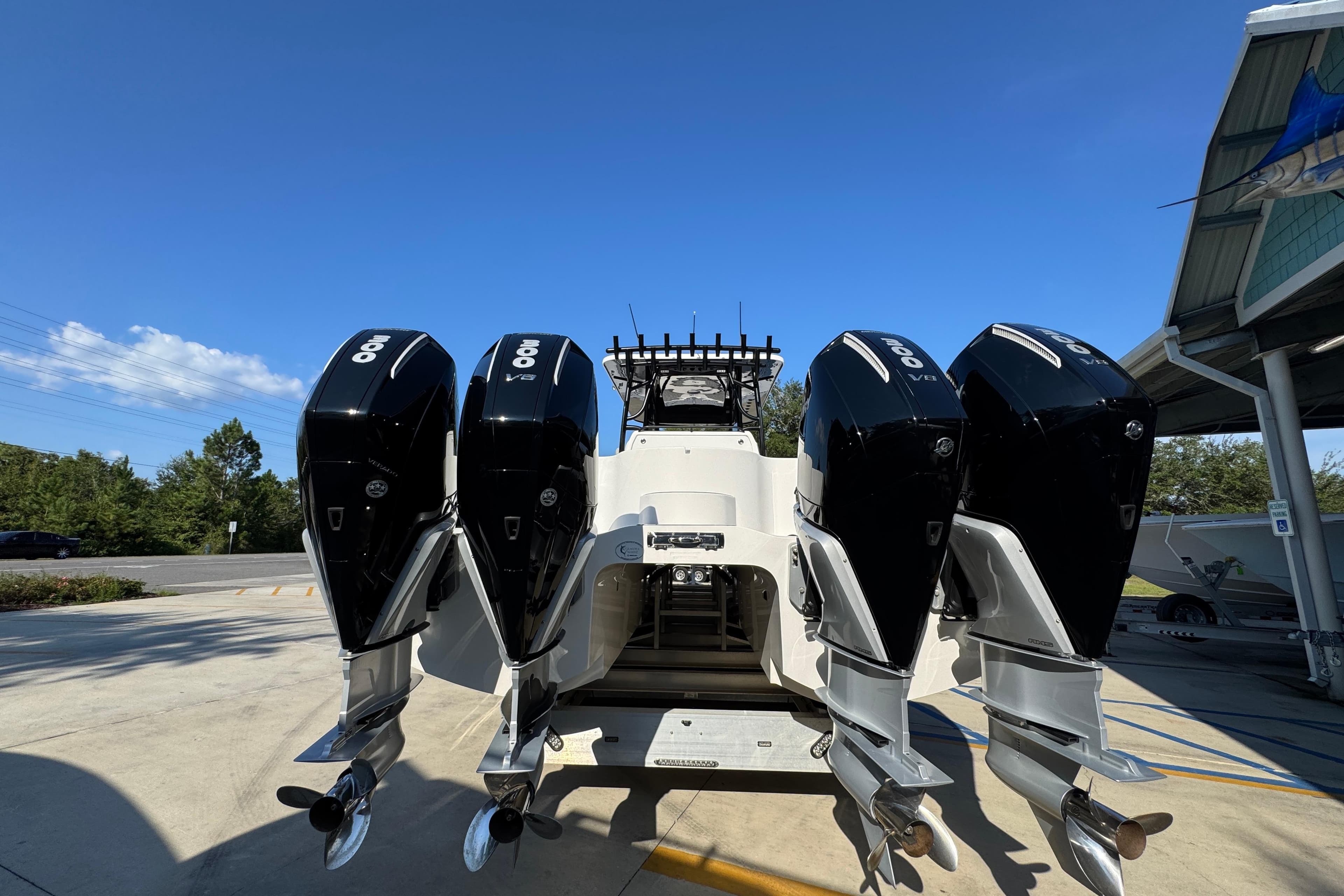 2023 Invincible 35 Catamaran with four powerful outboard engines, parked outdoors.