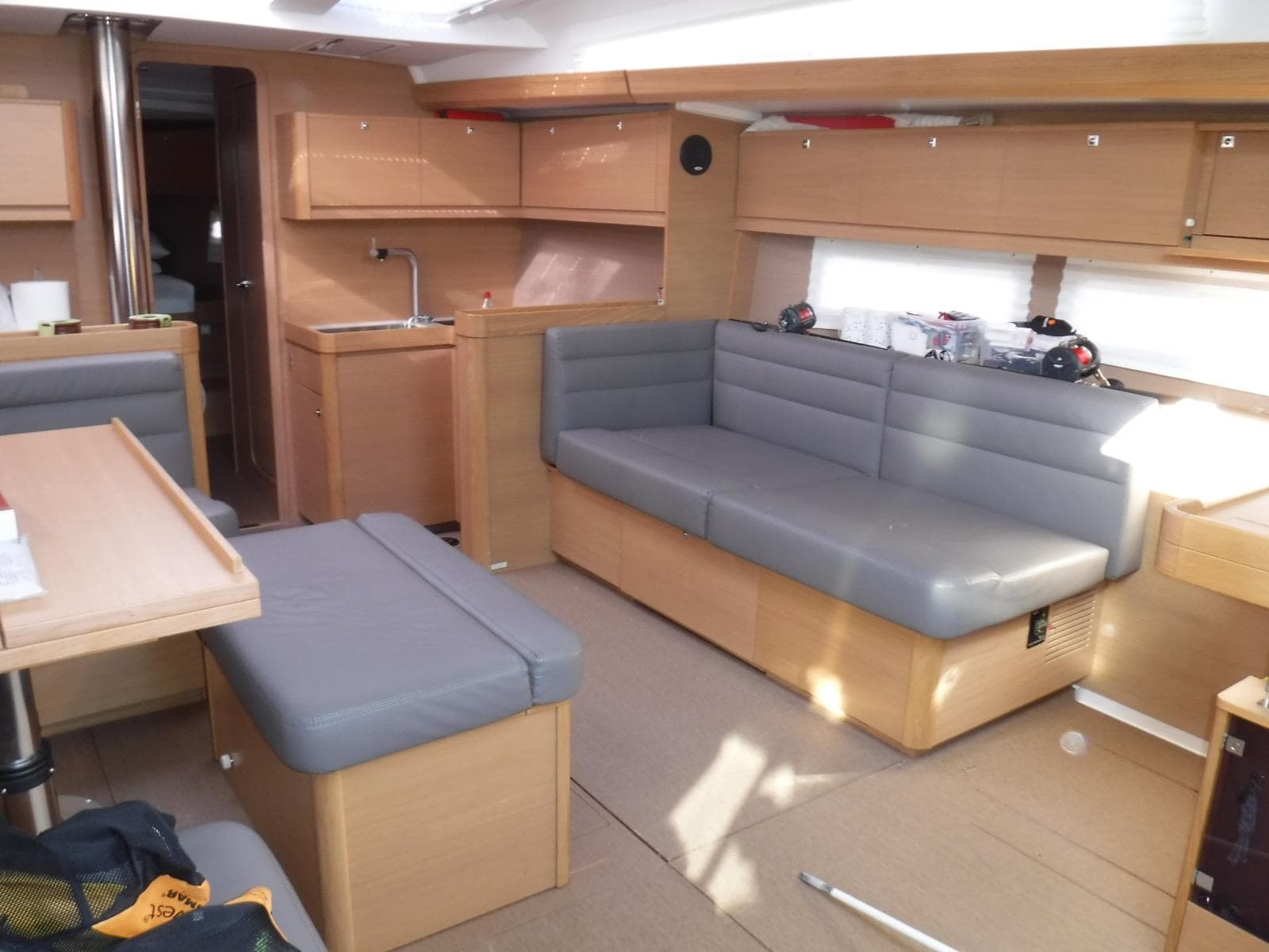 Interior of 2015 Dufour 500 Grand Large yacht with modern seating and kitchen area.