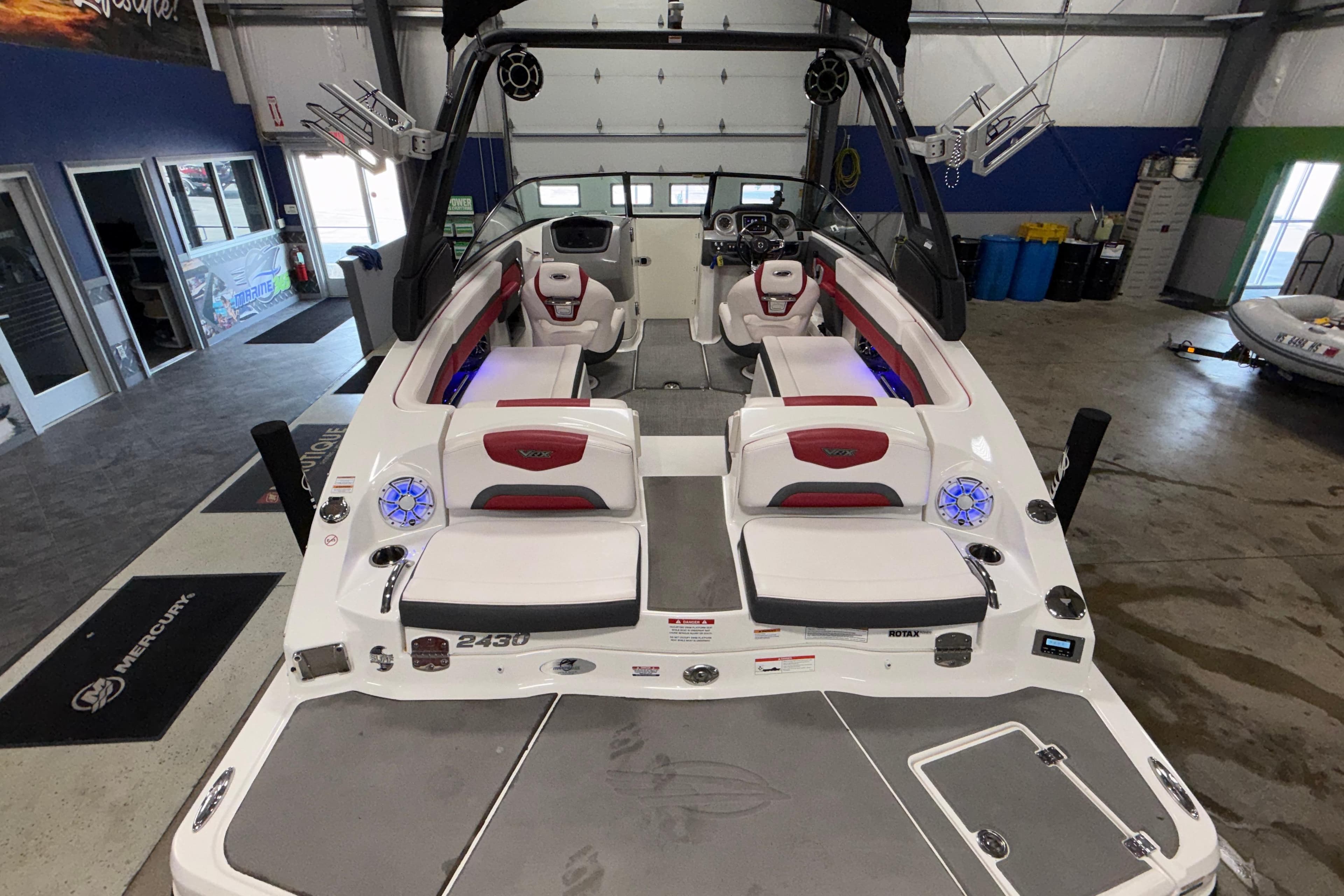 2019 Chaparral Vortex 2430 VRX Wake Series boat interior in showroom, featuring sleek seating and modern design.