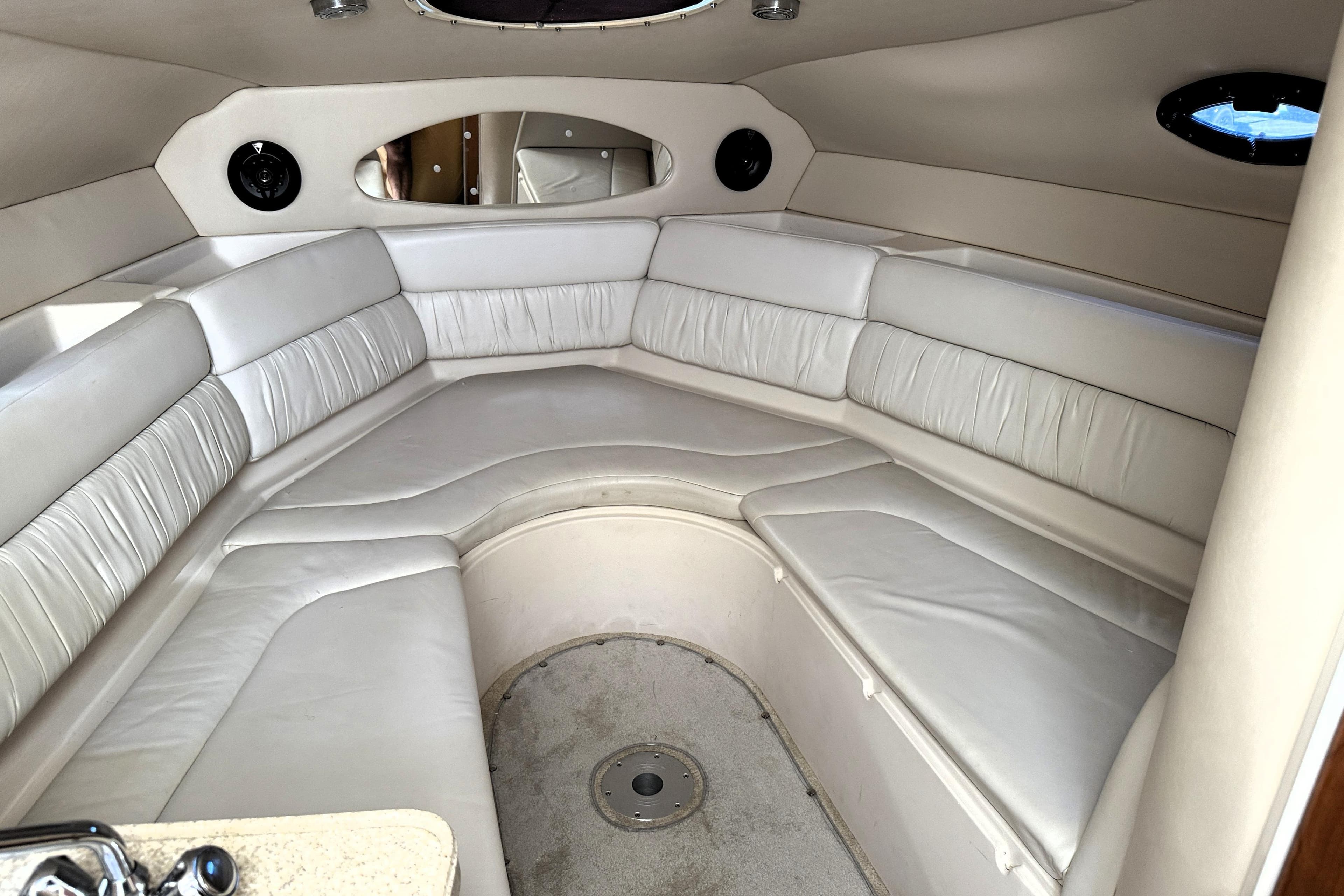 Interior of 2005 Regal Commodore 2665 boat with white leather seating.