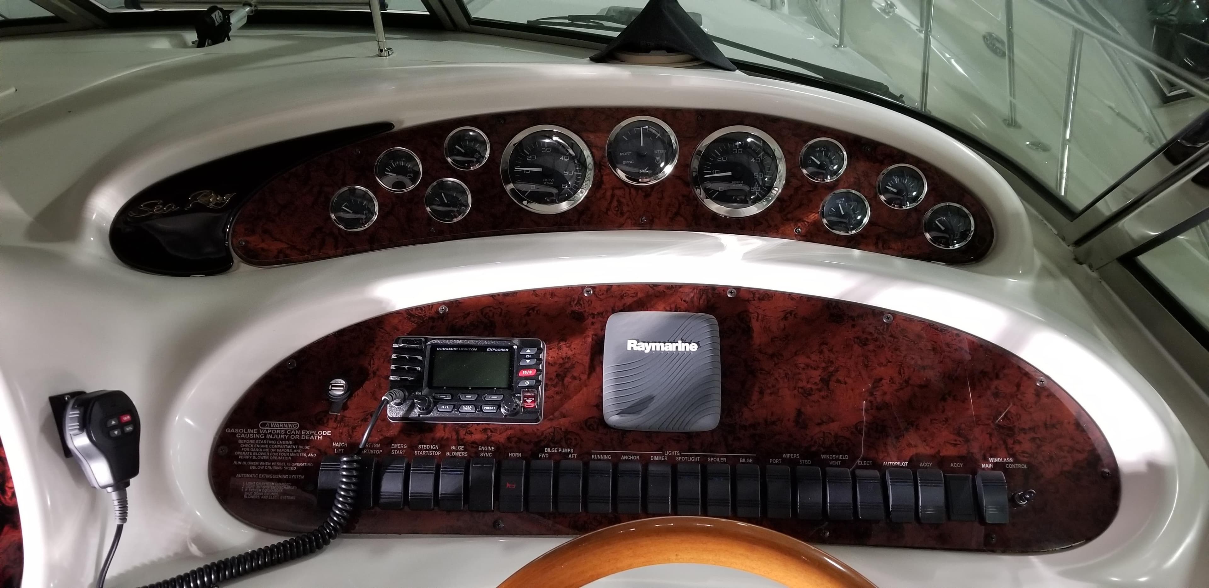 1999 Sea Ray 380 Sundancer dashboard with gauges and Raymarine equipment.