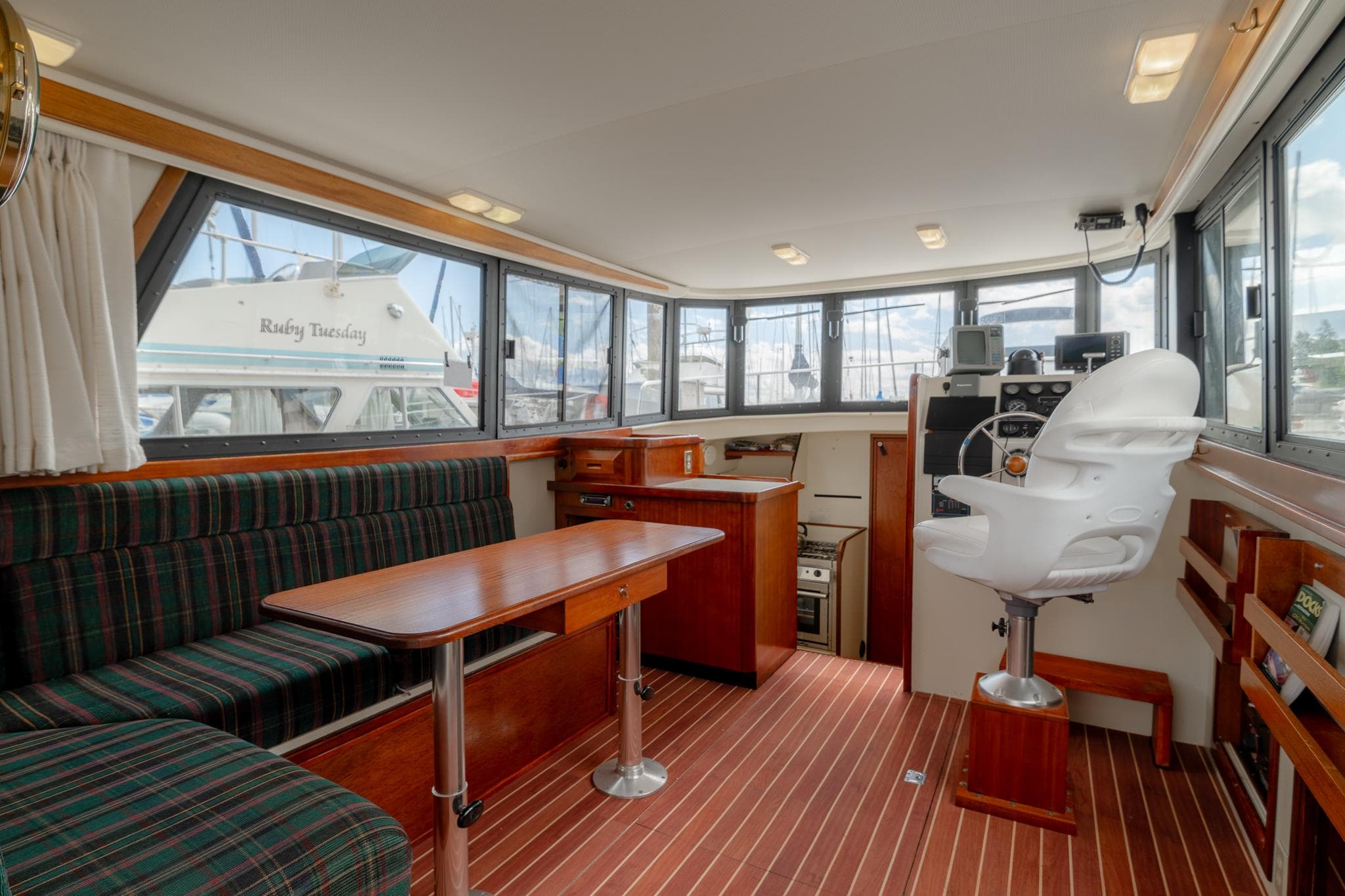 Interior of a 1996 Camano 31 yacht with wood flooring and helm station.