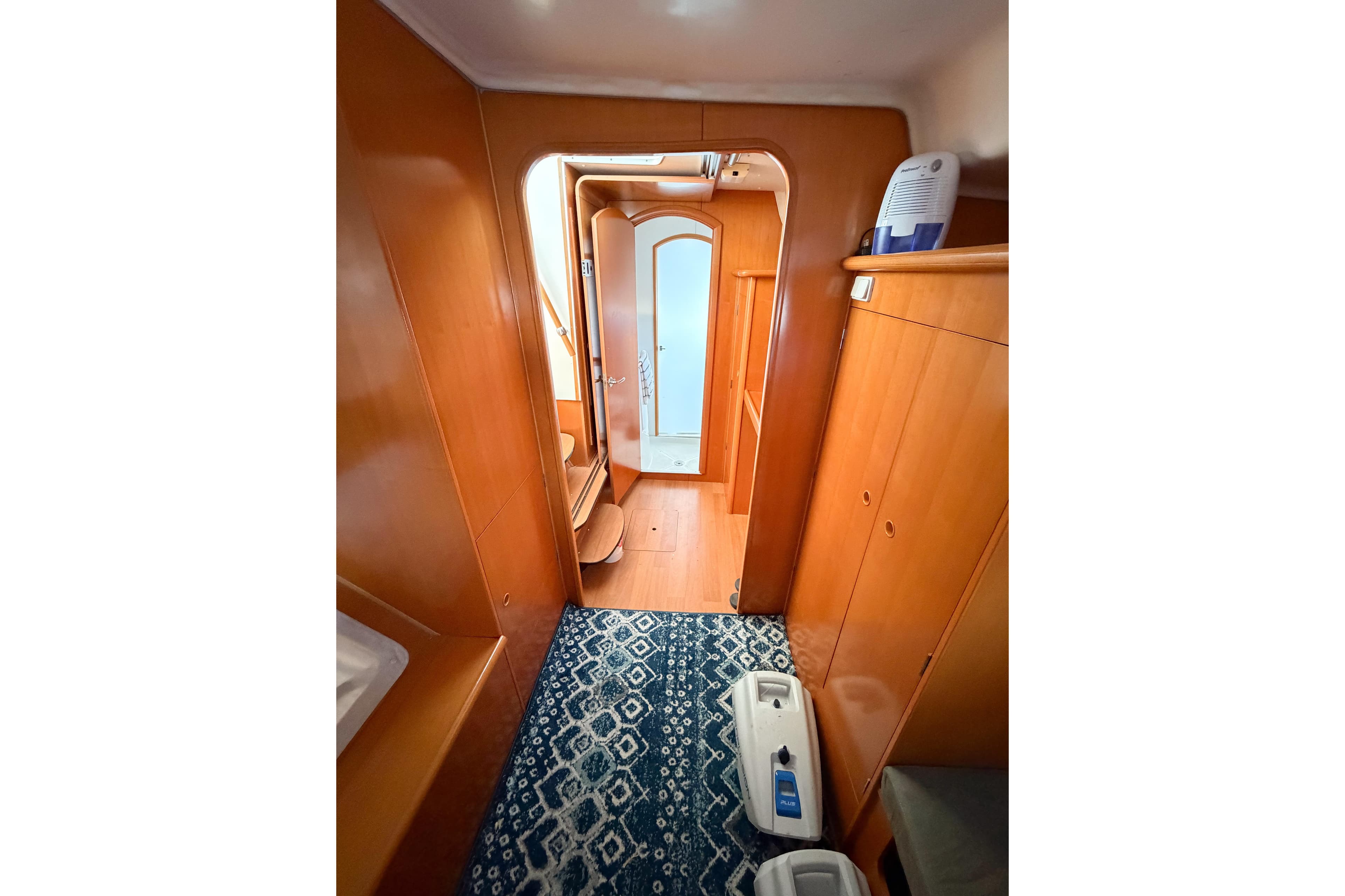 Interior of 2005 Lagoon 380 S2 yacht with wooden cabinetry and patterned rug.