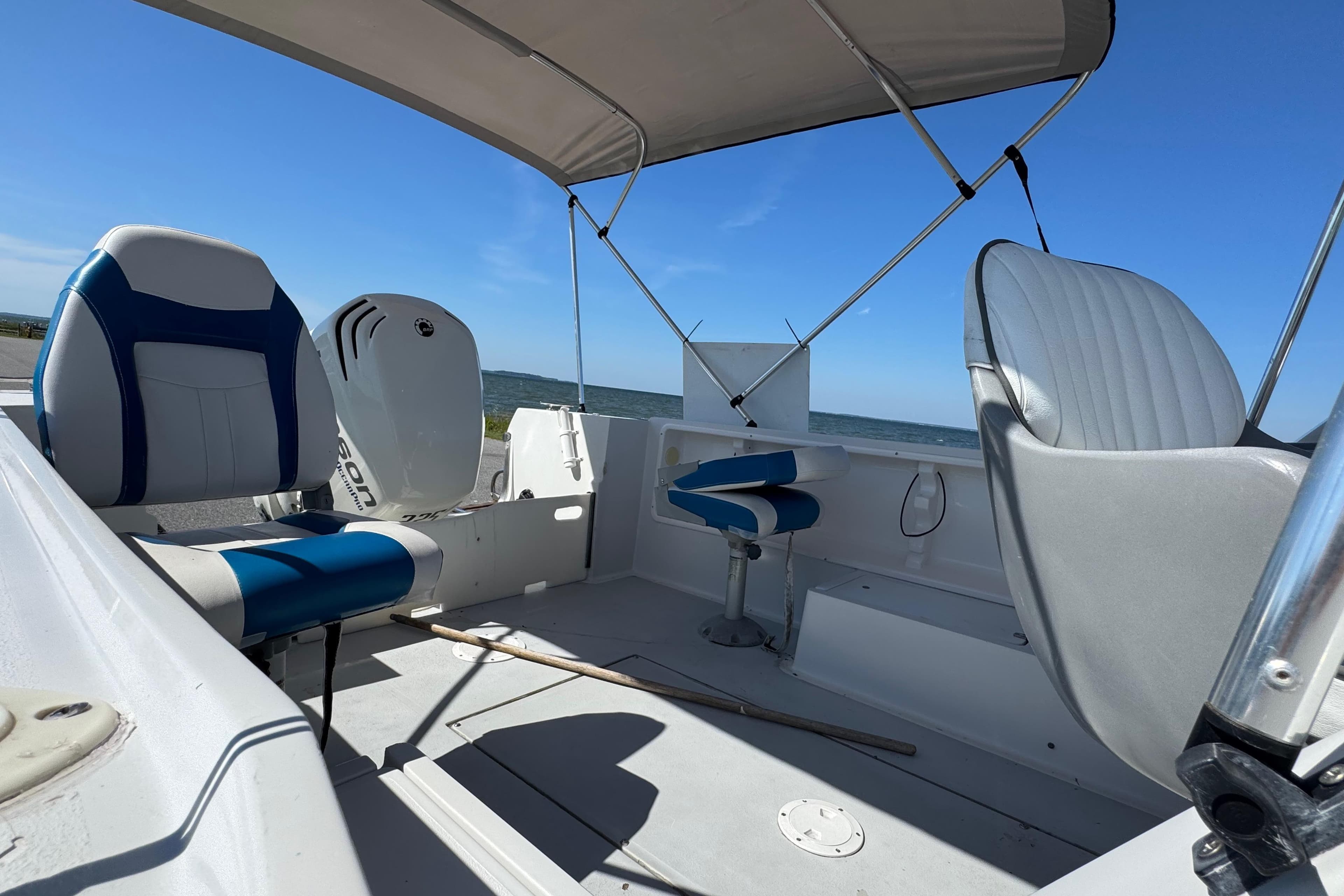 1988 Chris-Craft 215 Sea Hawk boat interior with seating and canopy, ocean view.