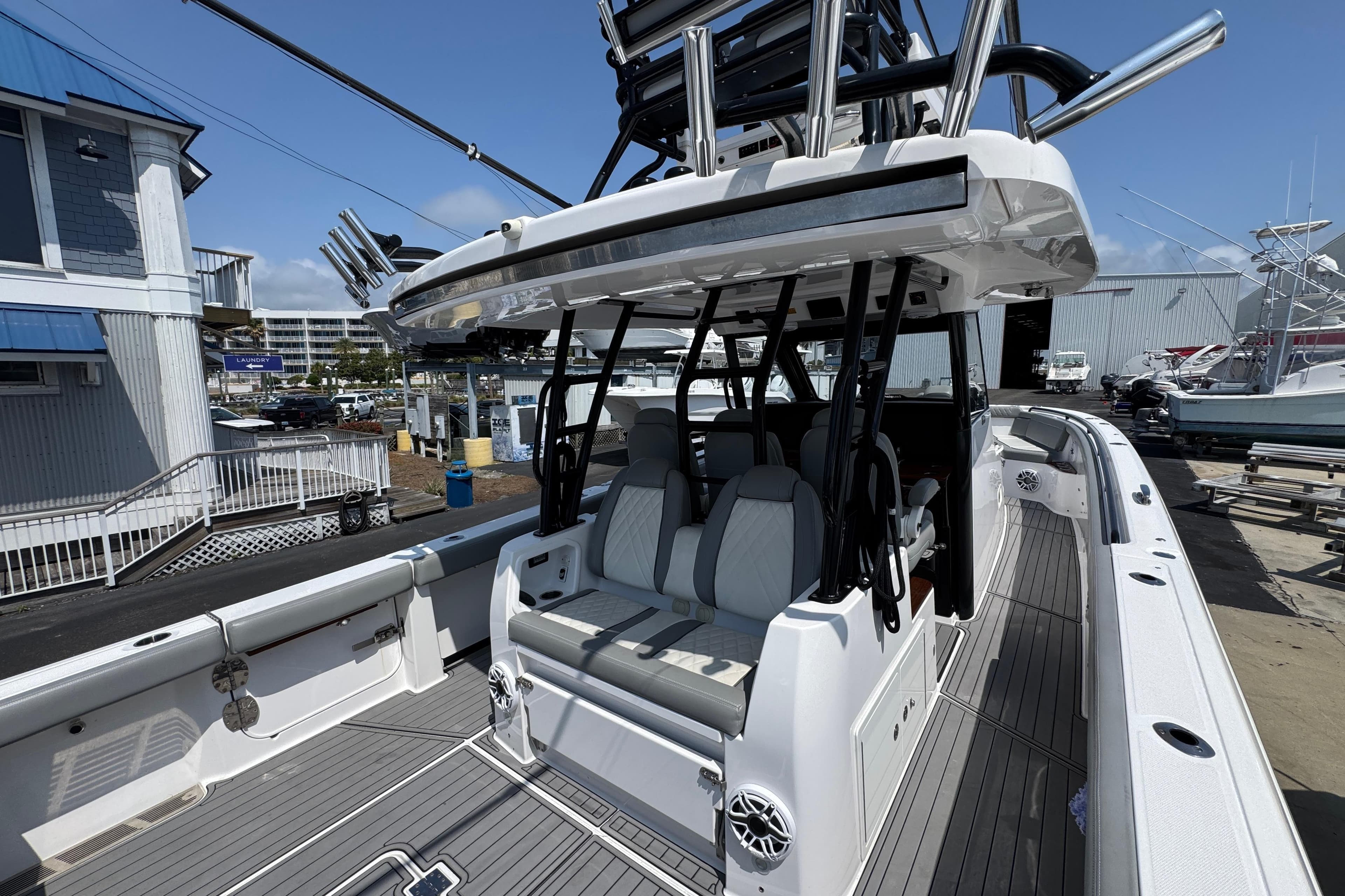 2022 Everglades 395 Center Console boat docked at a marina, showcasing seating and helm.