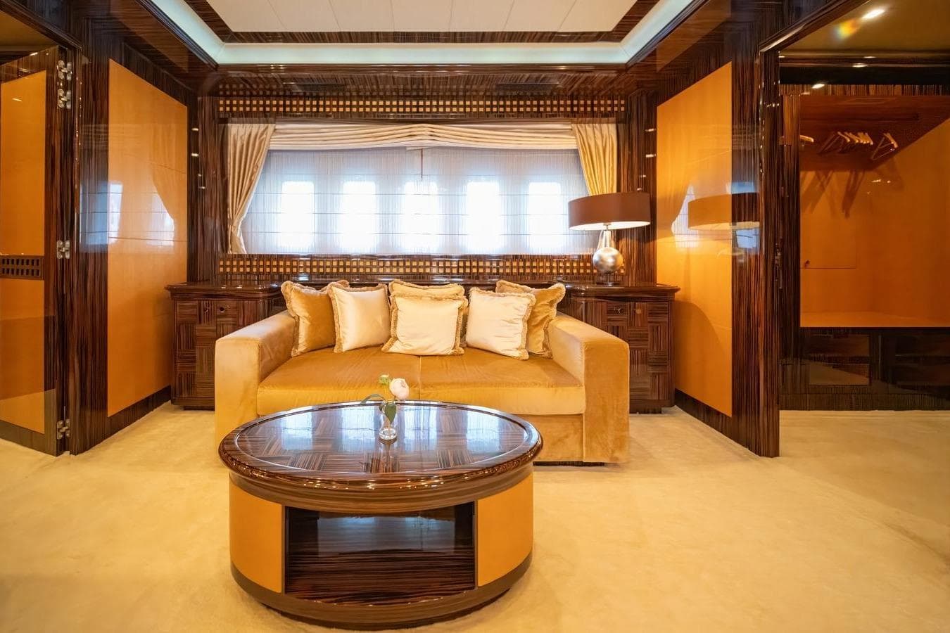 Luxurious interior of 2009 Mangusta 165 yacht with elegant sofa and stylish decor.