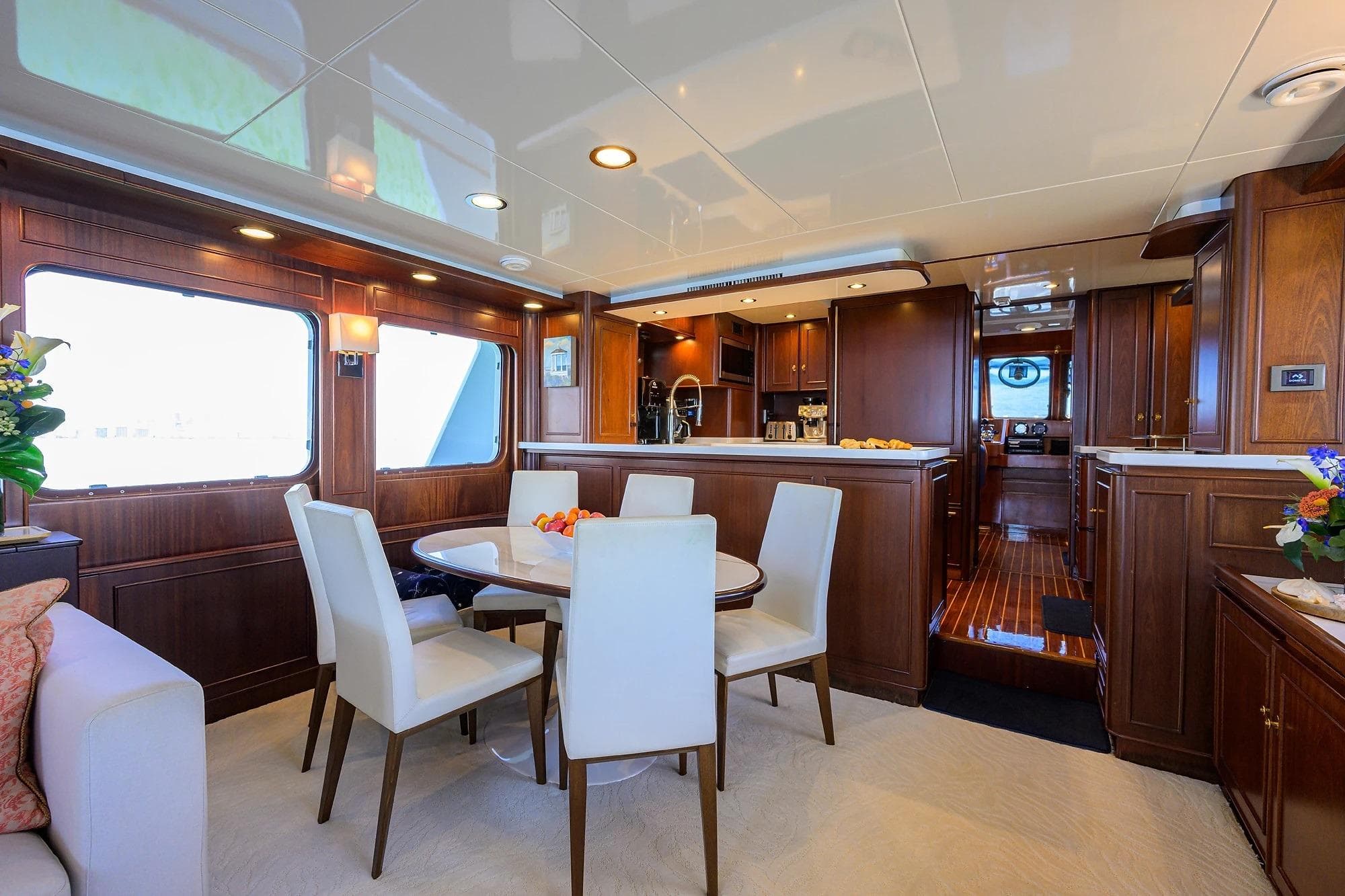 Luxurious interior of 1986 Jongert 85 yacht with elegant dining area and wooden cabinetry.