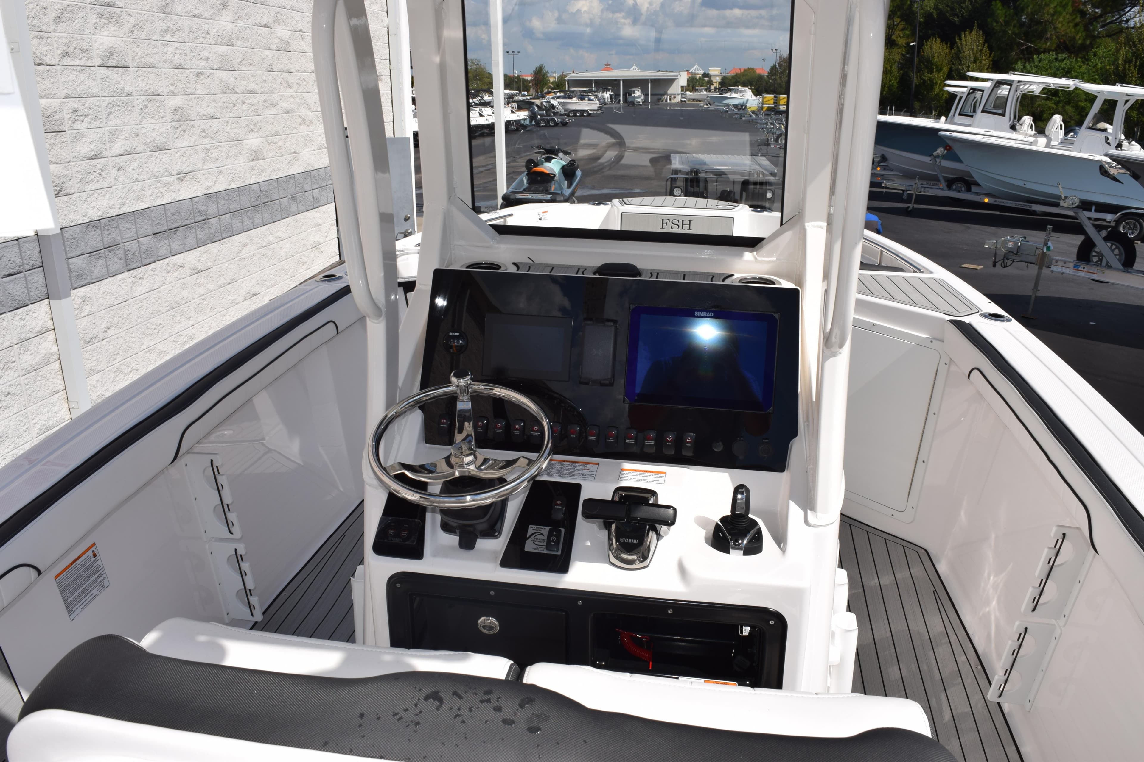 2026 Yamaha Boats 255 FSH Sport H helm with modern controls and navigation display.