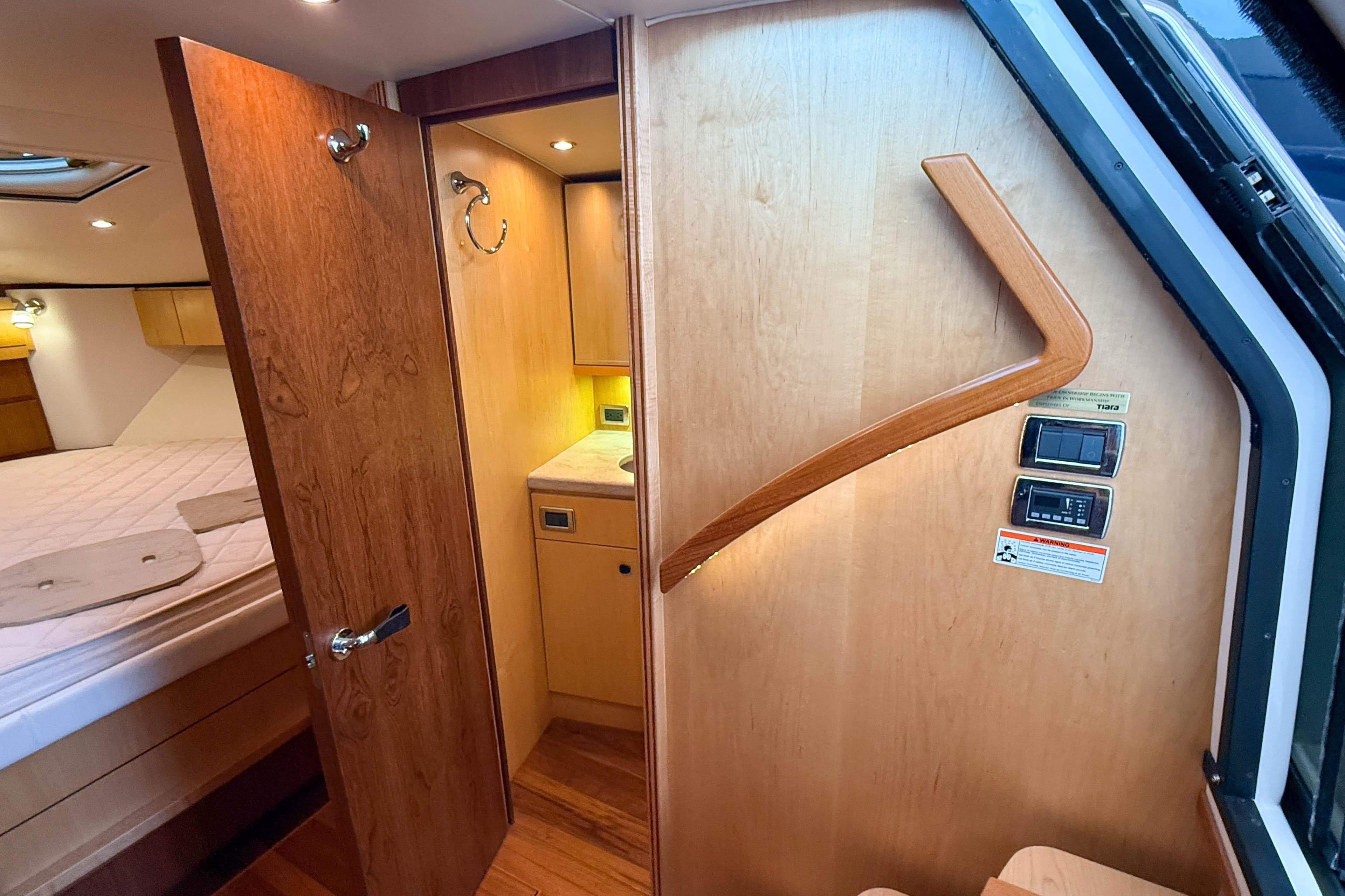 Interior of 2013 Tiara Yachts 3600 Coronet, featuring wood finishes and cozy cabin space.