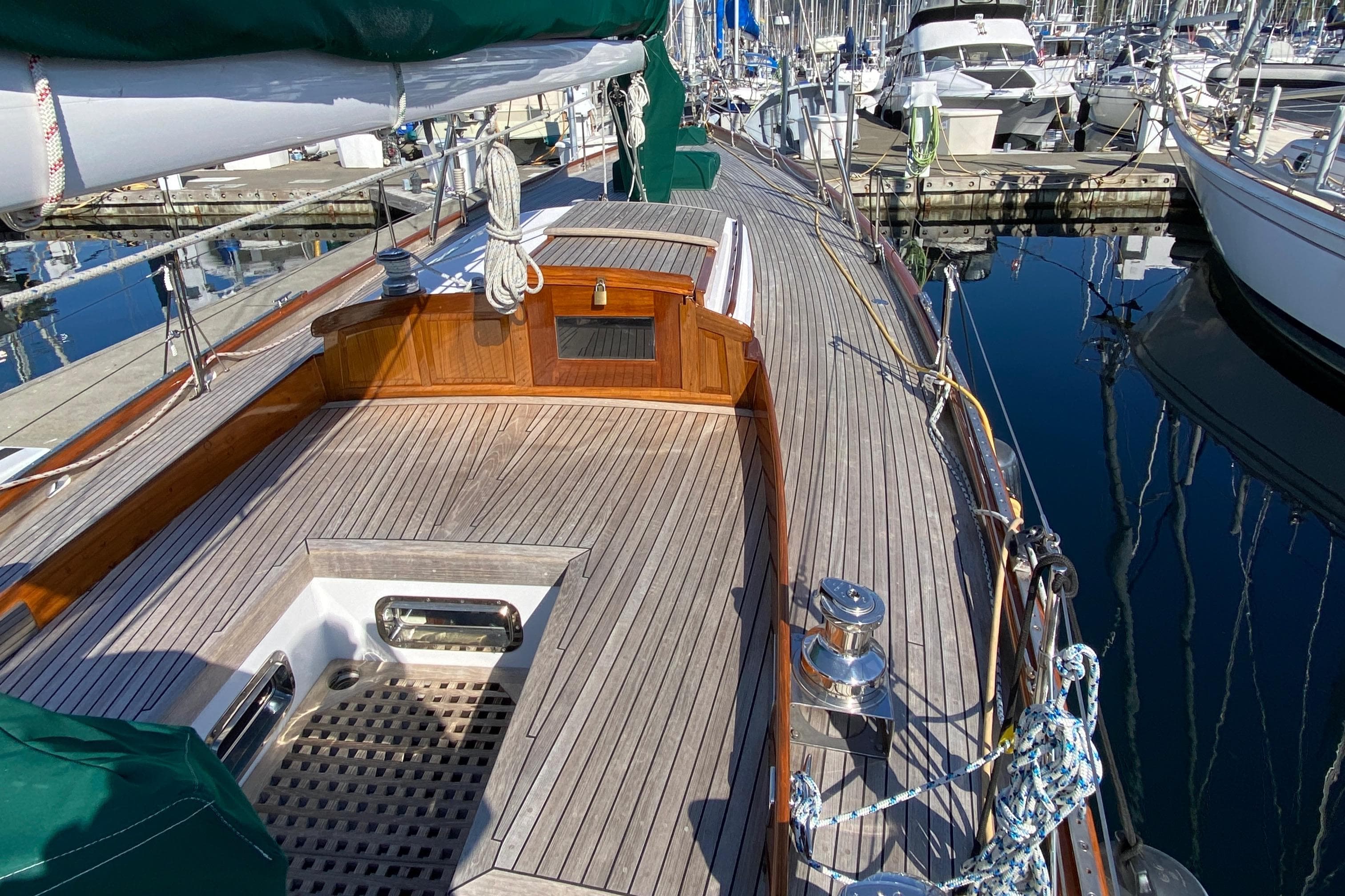 1962 Cheoy Lee Custom yacht with wooden deck, docked in a marina.