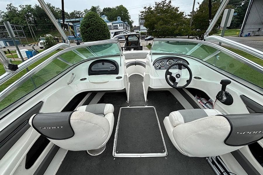 Interior view of a 2011 Sea Ray 205 Sport boat, featuring dual seating and steering console.