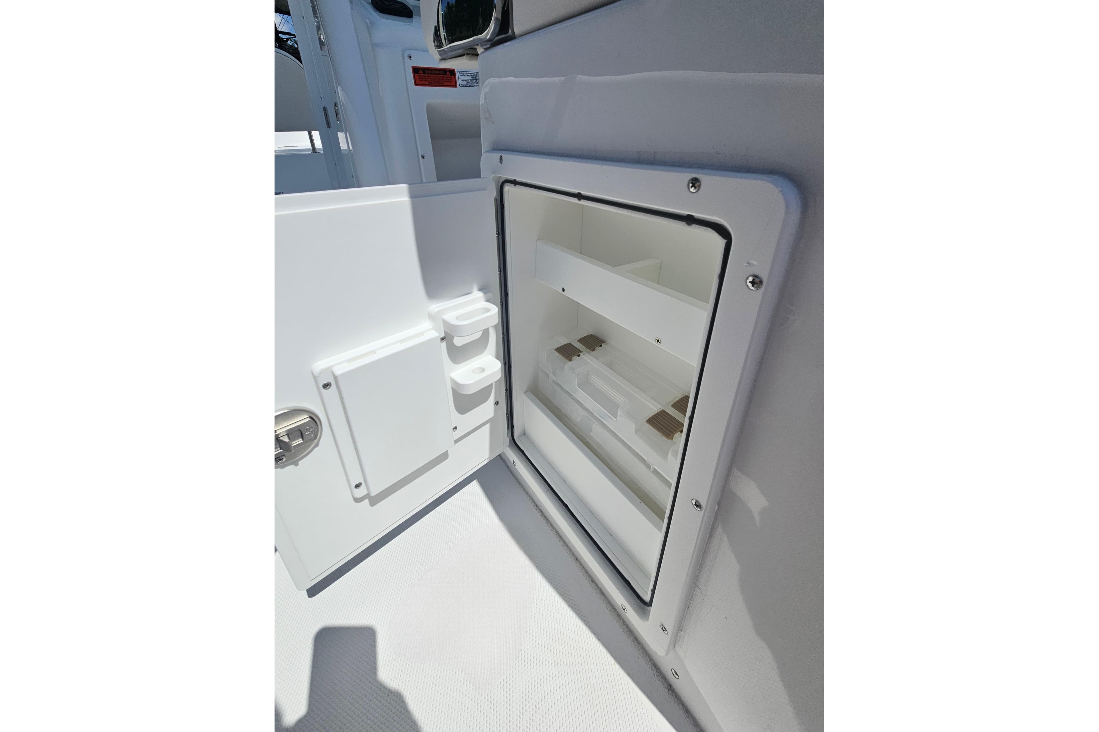 Open storage compartment on 2026 Sea Hunt Ultra 265 SE boat.