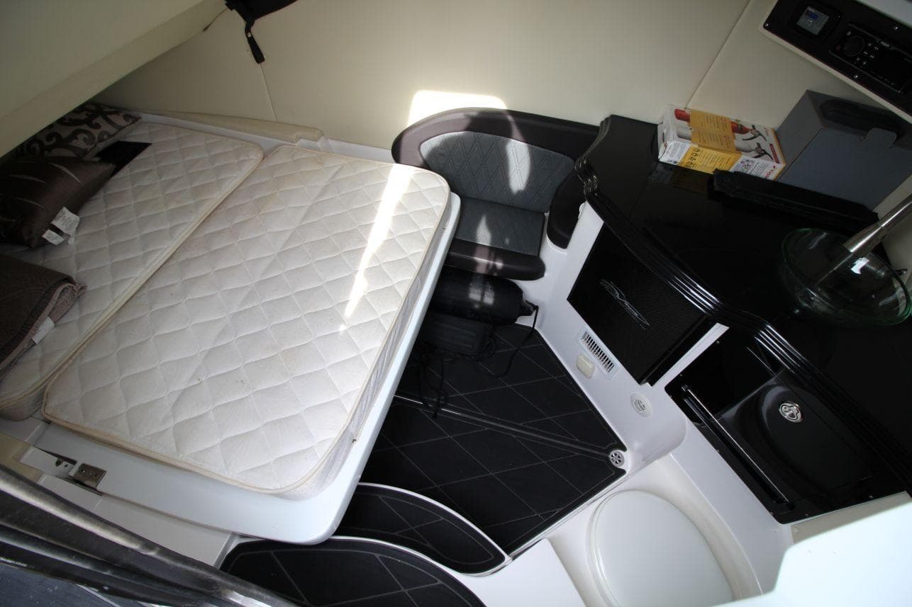 2018 MTI V42 cabin interior with bed, seating, and compact kitchenette.