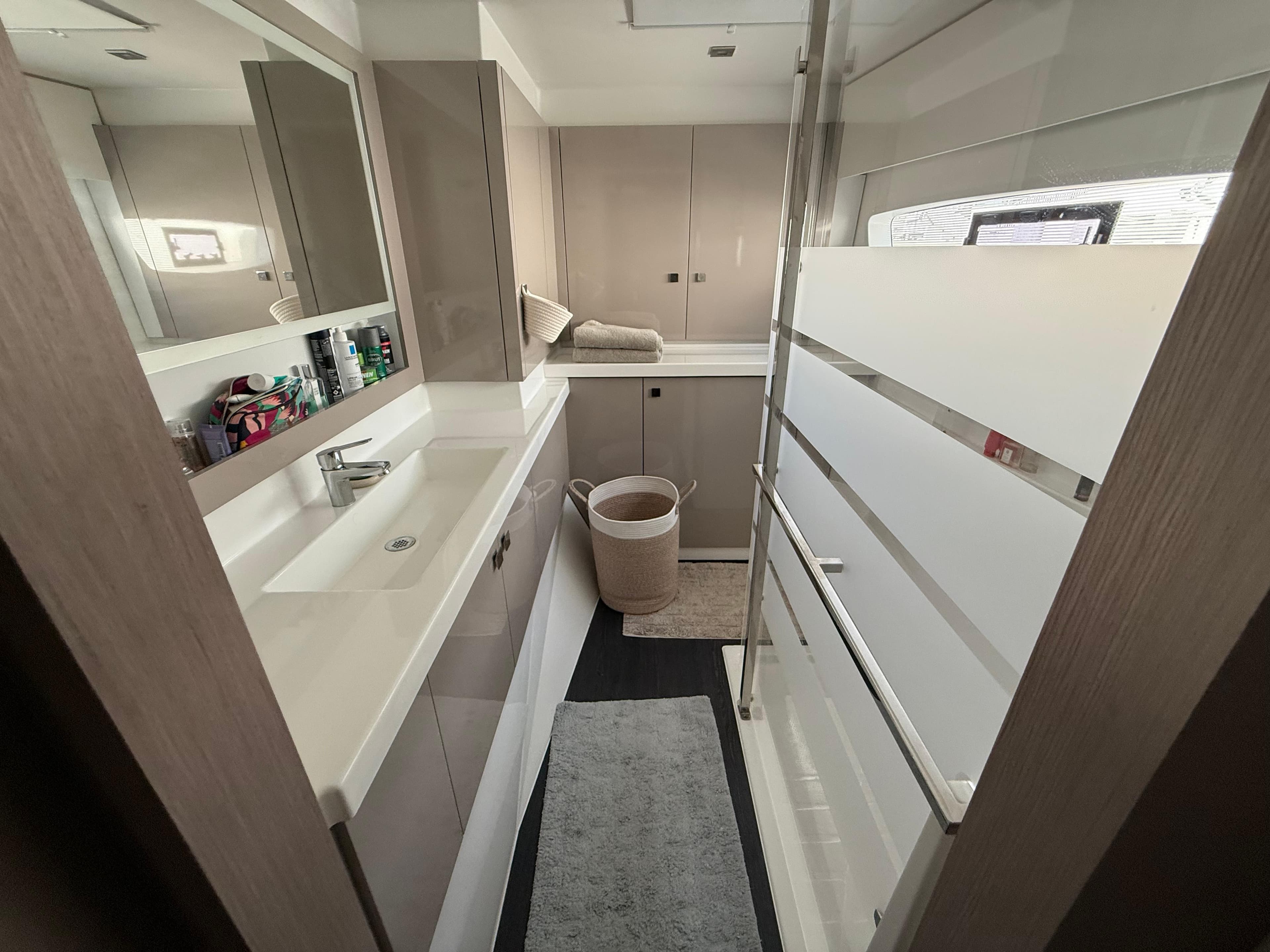 Modern bathroom interior on 2022 Fountaine Pajot Astrea 42 yacht, featuring sleek design and amenities.