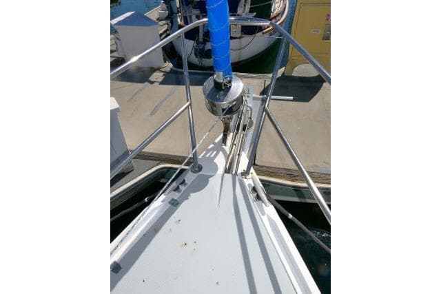 Bow of 1989 Catalina 34 sailboat docked, featuring stainless steel railings and anchor system.