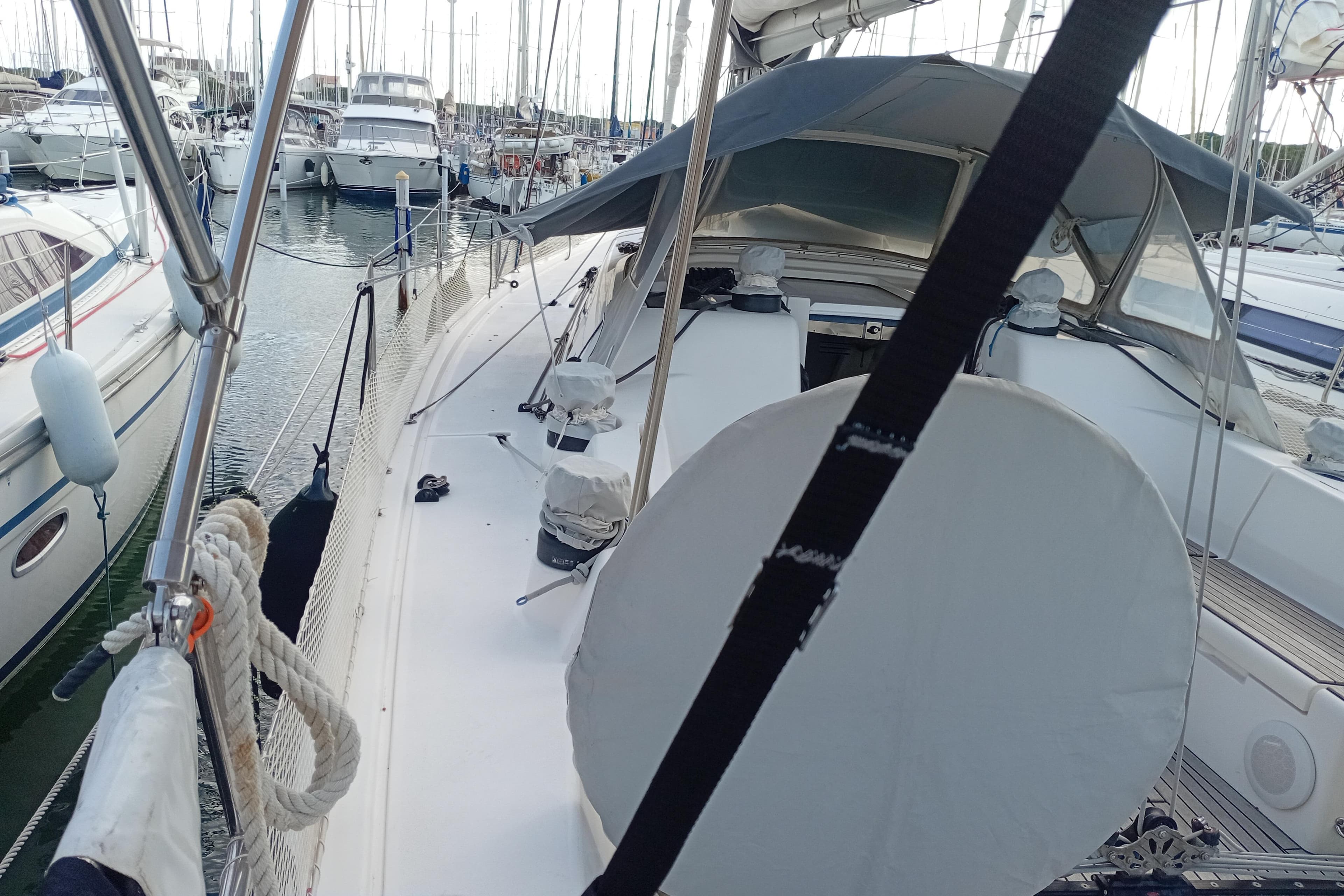 2016 X-Yachts Xp 38 sailboat docked in a marina, surrounded by other boats.