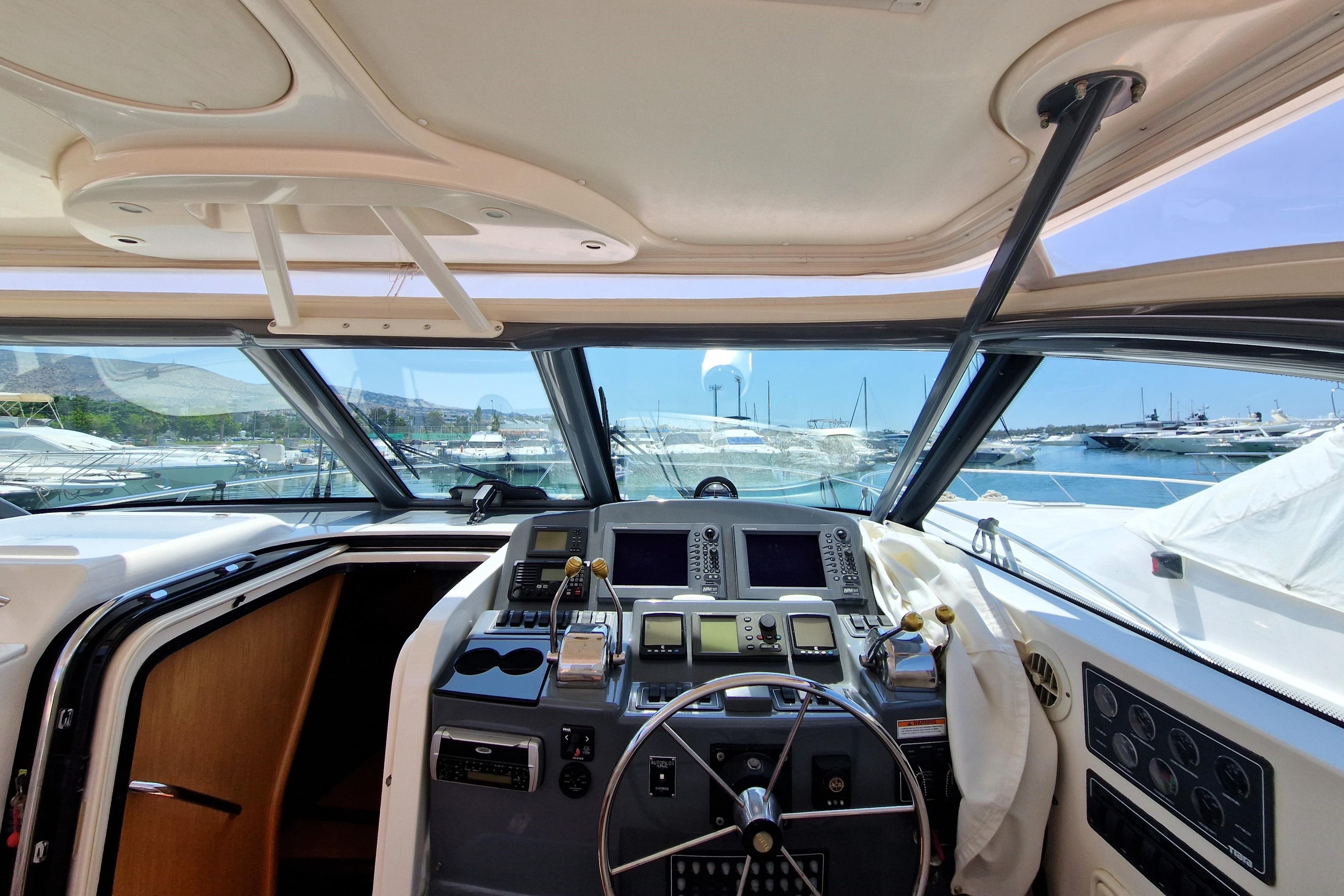 2005 Tiara Yachts 4200 Open helm with navigation equipment and marina view.