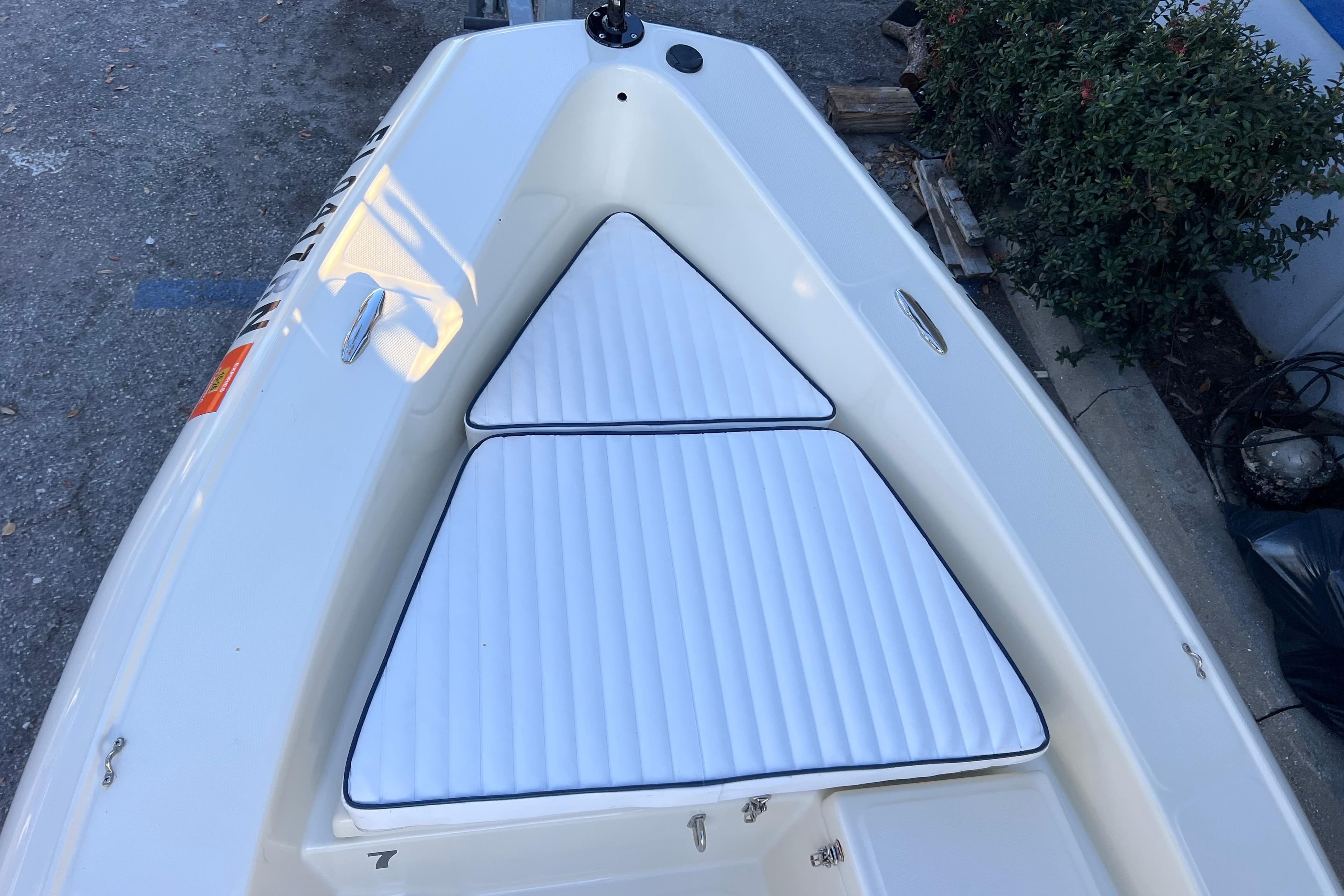2017 Rigid Boats 14 Sport with white cushioned seating, docked outdoors.