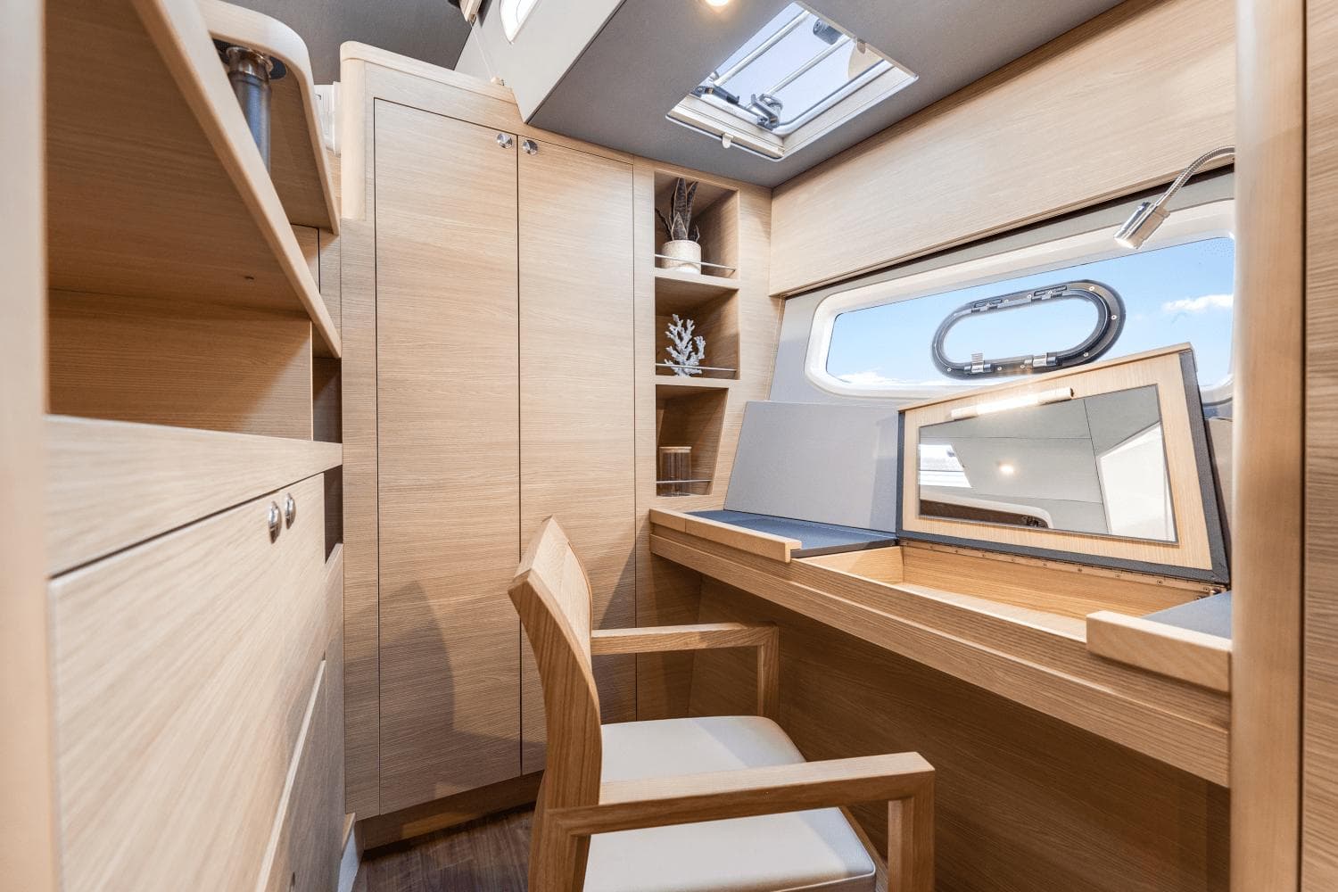 2024 Aquila 44 Yacht interior cabin with wooden furniture and skylight.