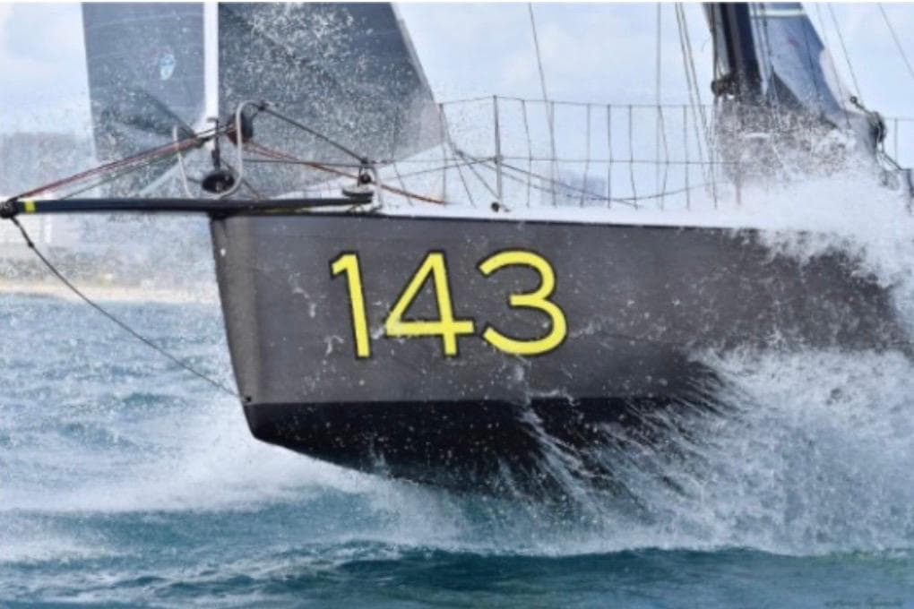 Sailing yacht Class 40 Owen Clarke Design 2015, number 143, cutting through waves.