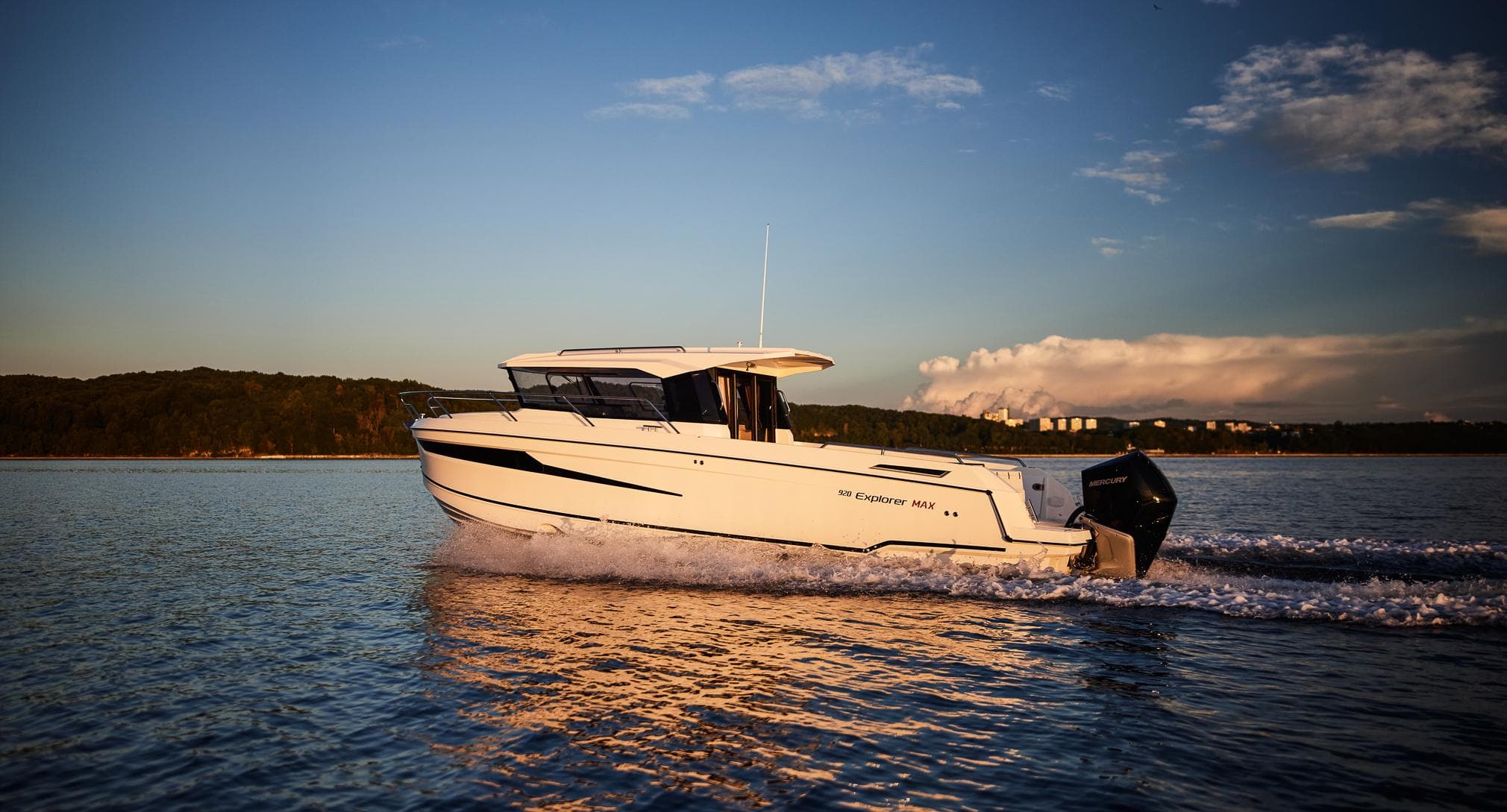 2024 Skamander 920 Explorer MAX cruising on a serene lake at sunset.