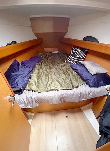 Cozy cabin interior of 2018 Jeanneau Sun Odyssey 389 sailboat with bed and pillows.