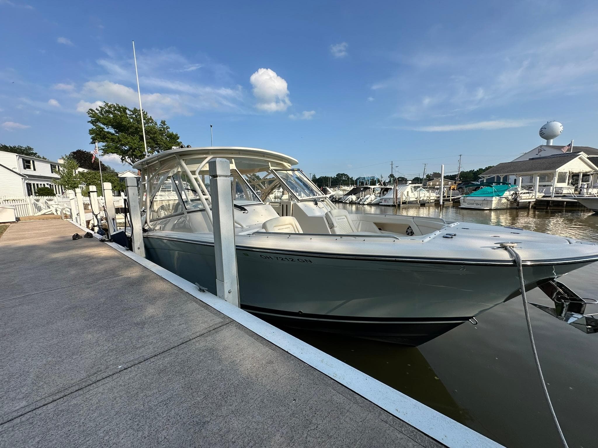 2024 Grady-White Freedom 335 boat docked at a marina under a clear blue sky.